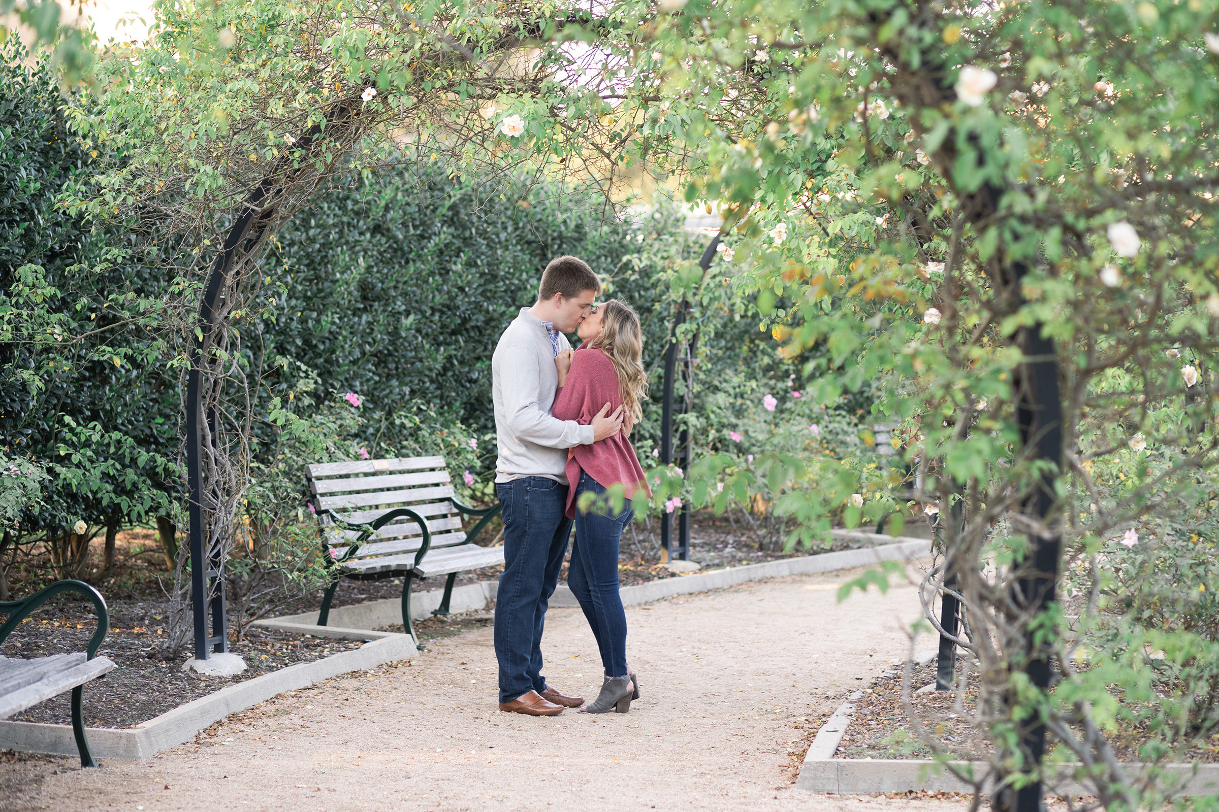 couple kisses during their engagement session at McGovern Centennial Gardens by Swish and Click Photography