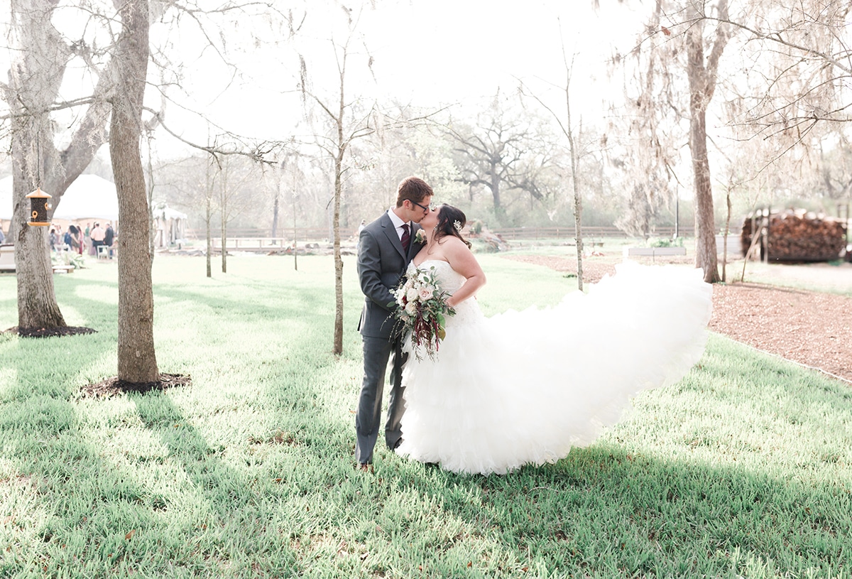 wedding couple kisses during their amazing wedding pictures in Houston Texas by Swish and Click Photography