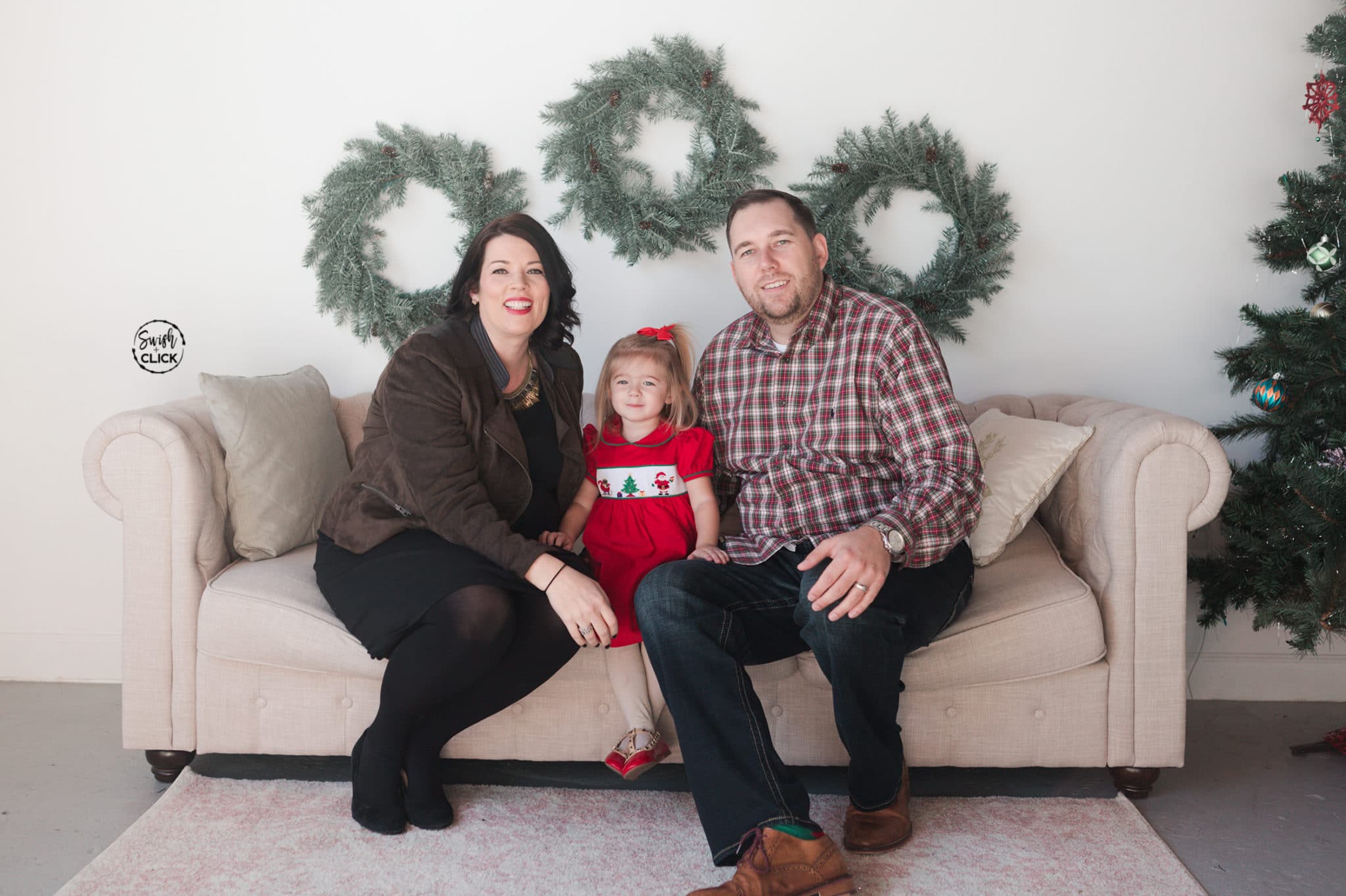 family smiles during their Christmas portraits in Houston Texas by Swish and Click Photography