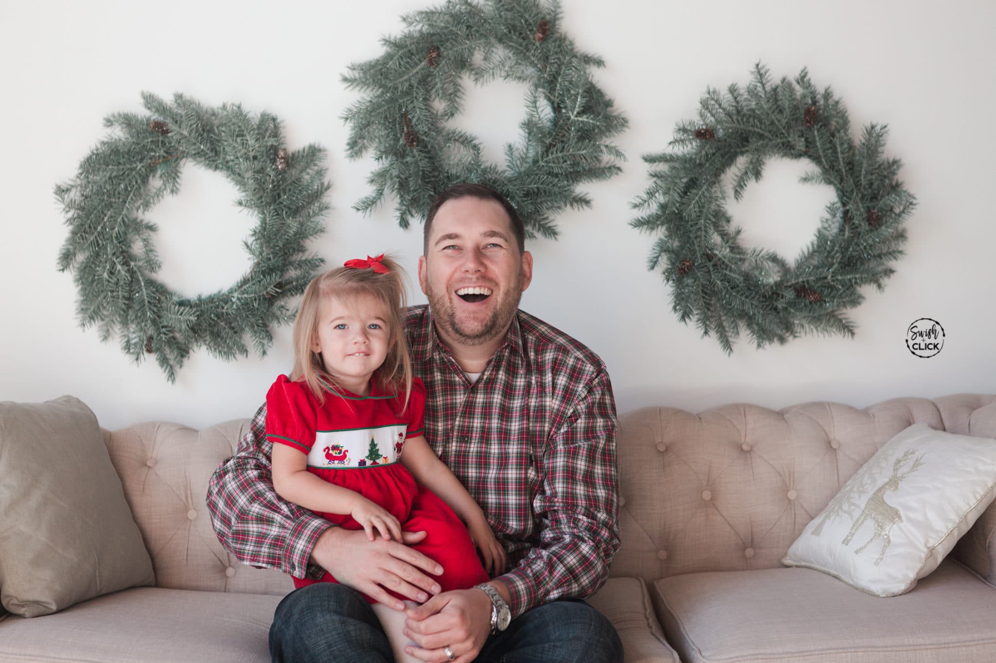 father and daughter smile during their Christmas portraits in Houston Texas by Swish and Click Photography