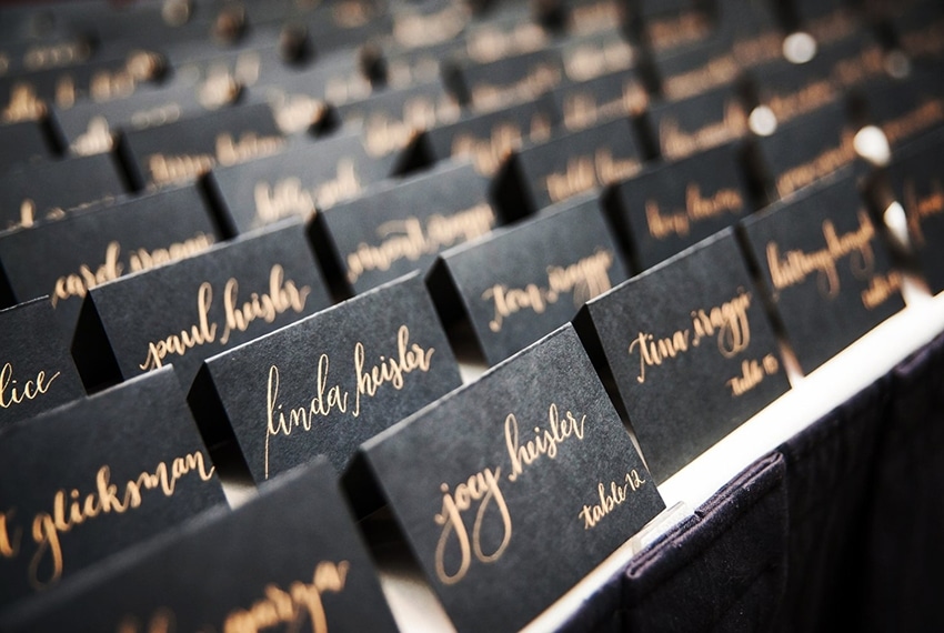 Houston calligrapher Megan Marie inscribes names onto paper at a wedding at the Dunlavy in Houston TX