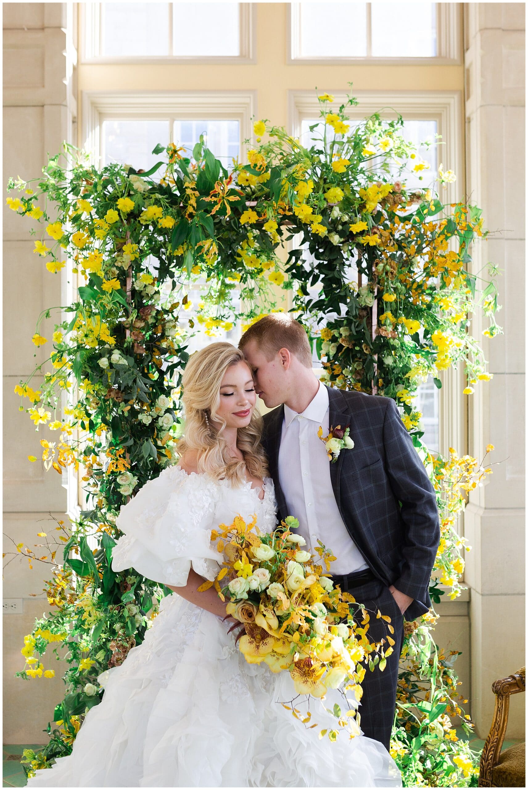 bride and groom kiss on wedding day at The Olana in Hickory Creek, Texas in a yellow themed wedding captured by Swish and Click Photography