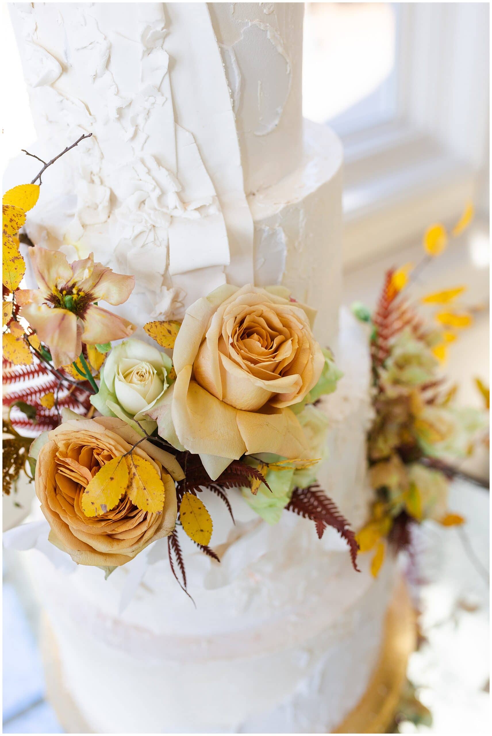 wedding cake on wedding day at The Olana in Hickory Creek, Texas in a yellow themed wedding captured by Swish and Click Photography