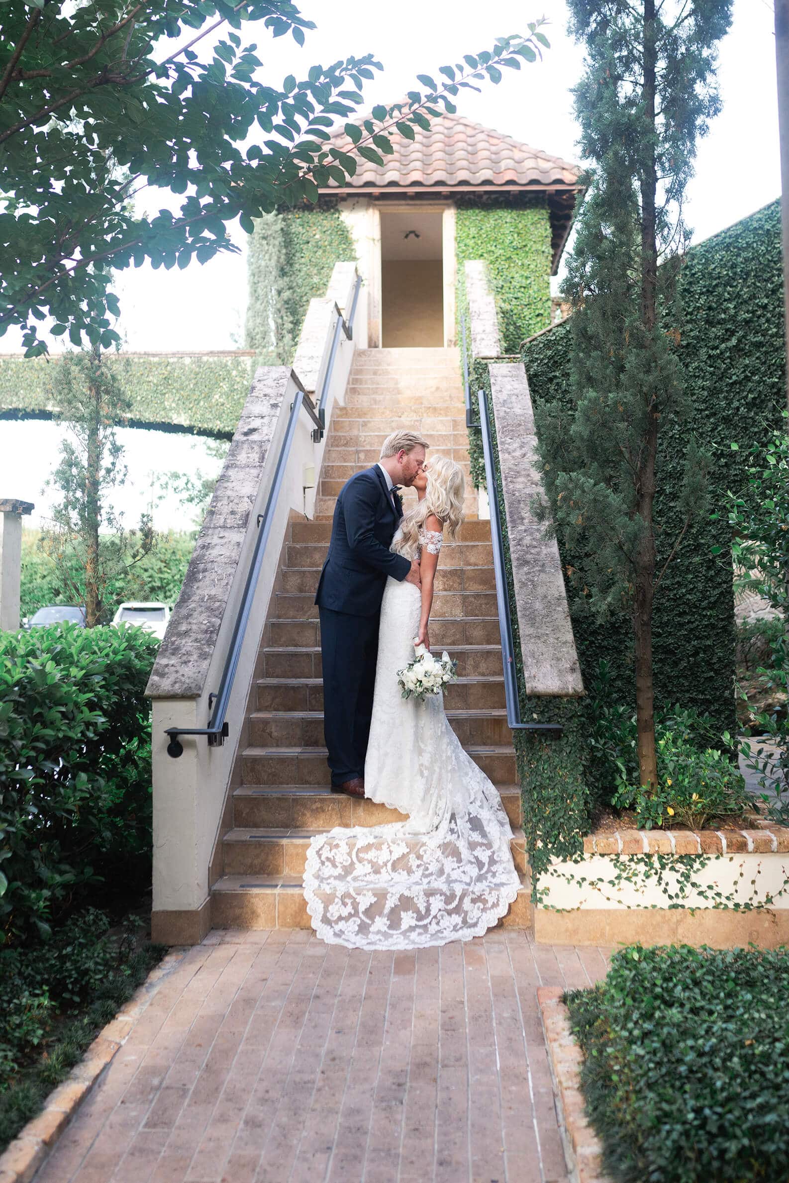 bride and groom kissing at The Bell Tower on 34th in Houston Texas by Swish and Click photography