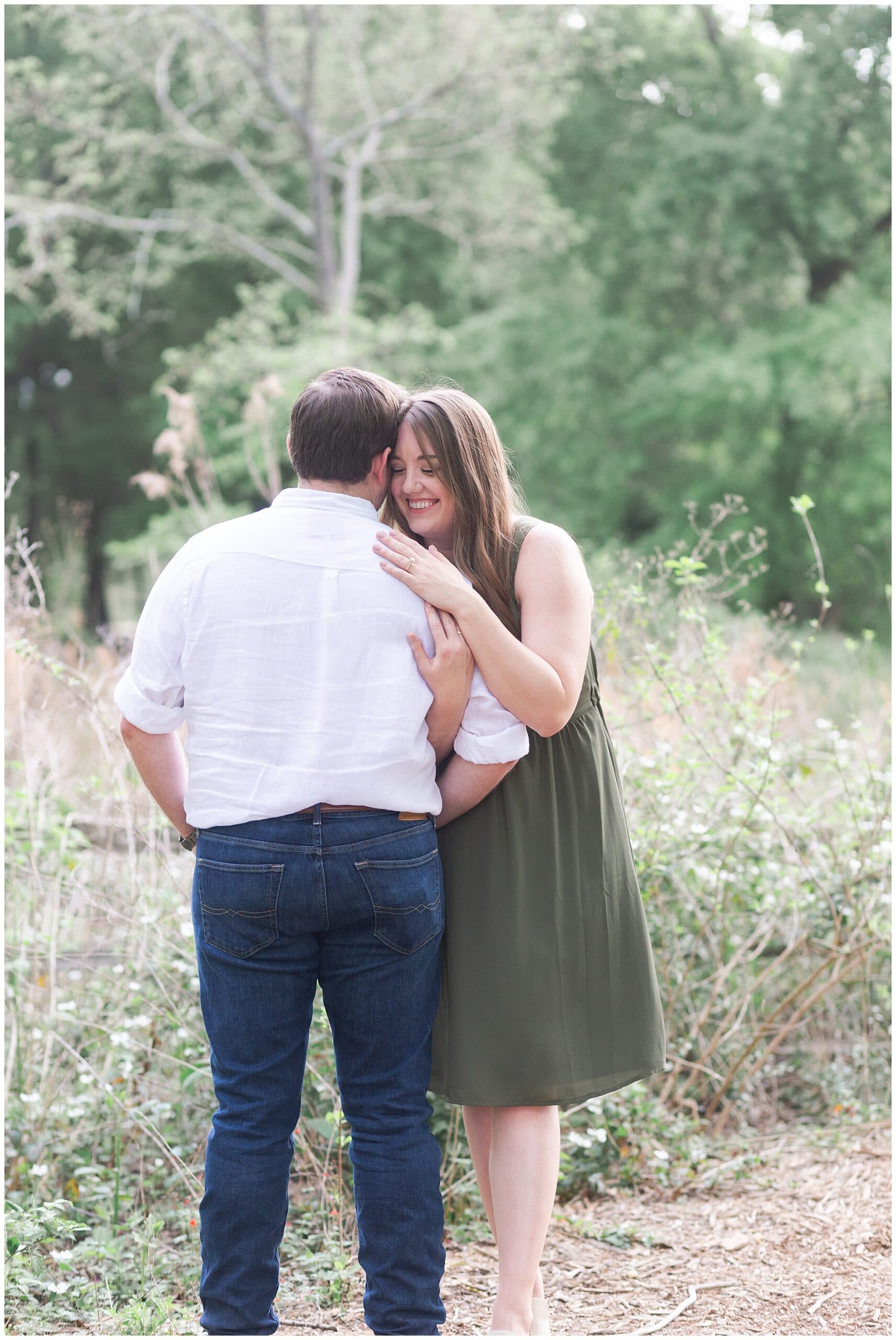 couple laughing in Houston Arboretum and Nature Center during their engagement session by Swish and Click Photography