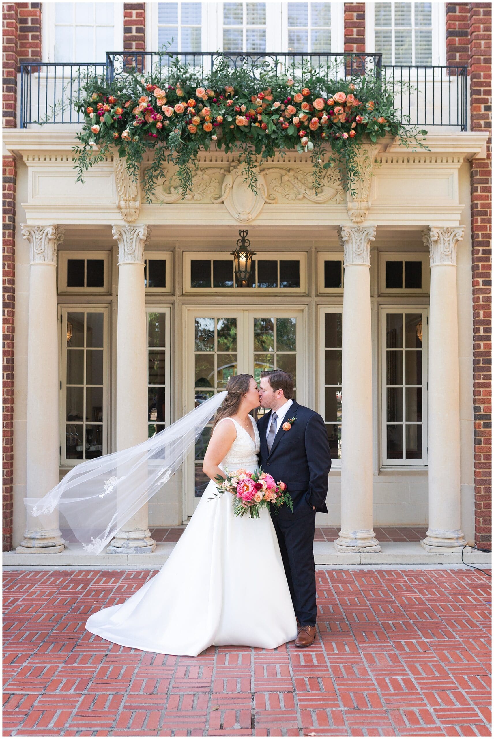 bride and groom kissing at Astin Mansion in Bryan Texas by Swish and Click Photography