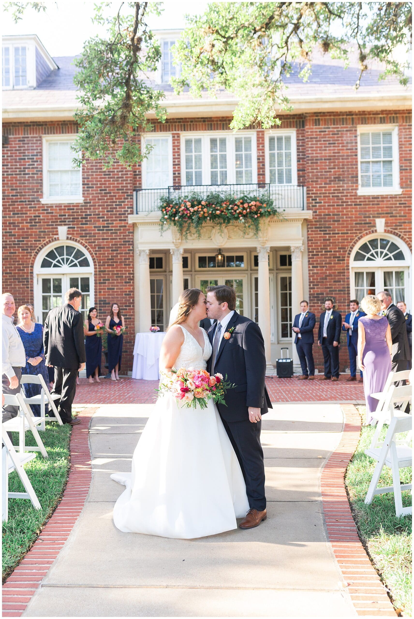 first kiss at wedding ceremony at Astin Mansion in Bryan Texas by Swish and Click Photography