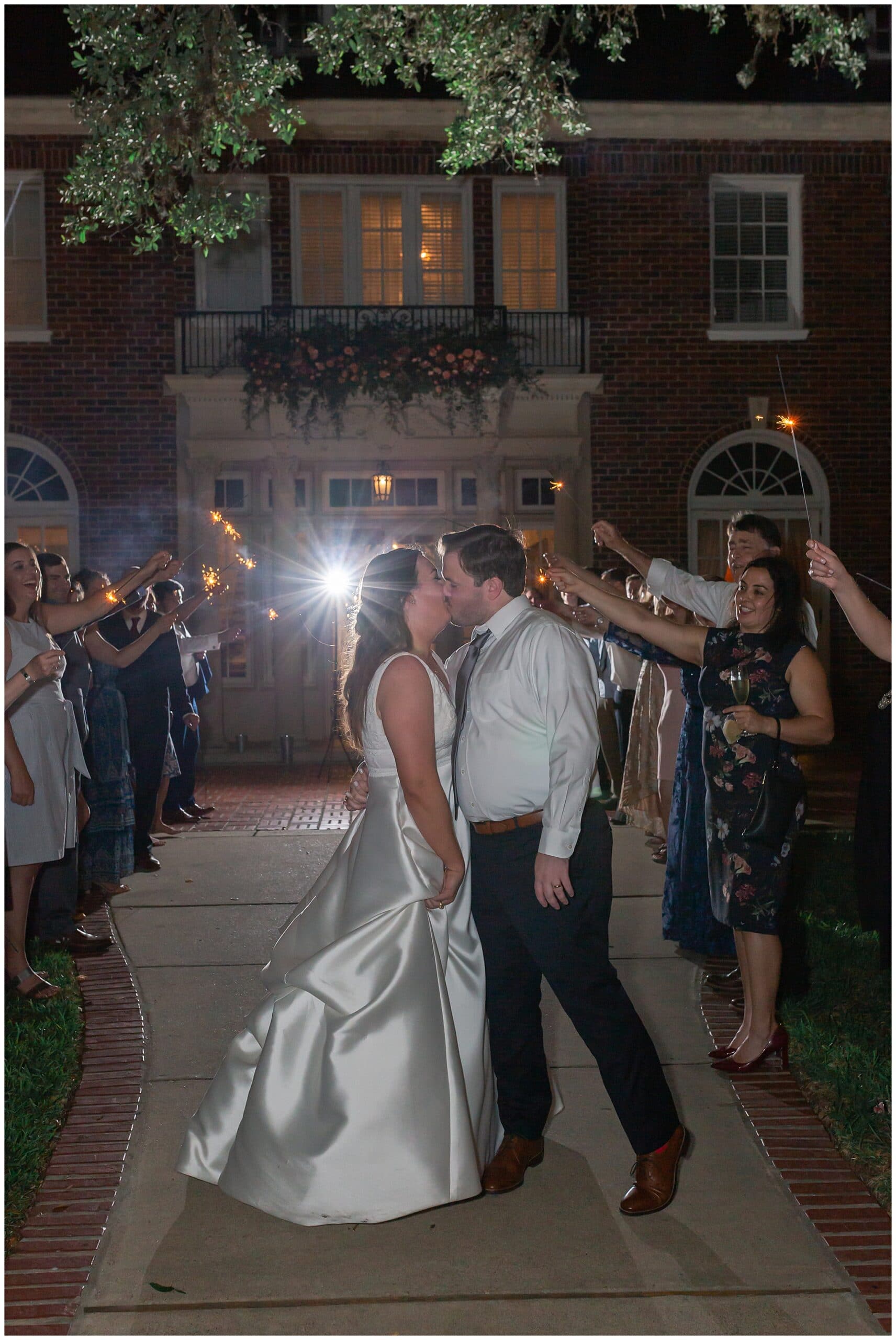 grand exit with bride and groom kissing at Astin Mansion in Bryan Texas by Swish and Click Photography