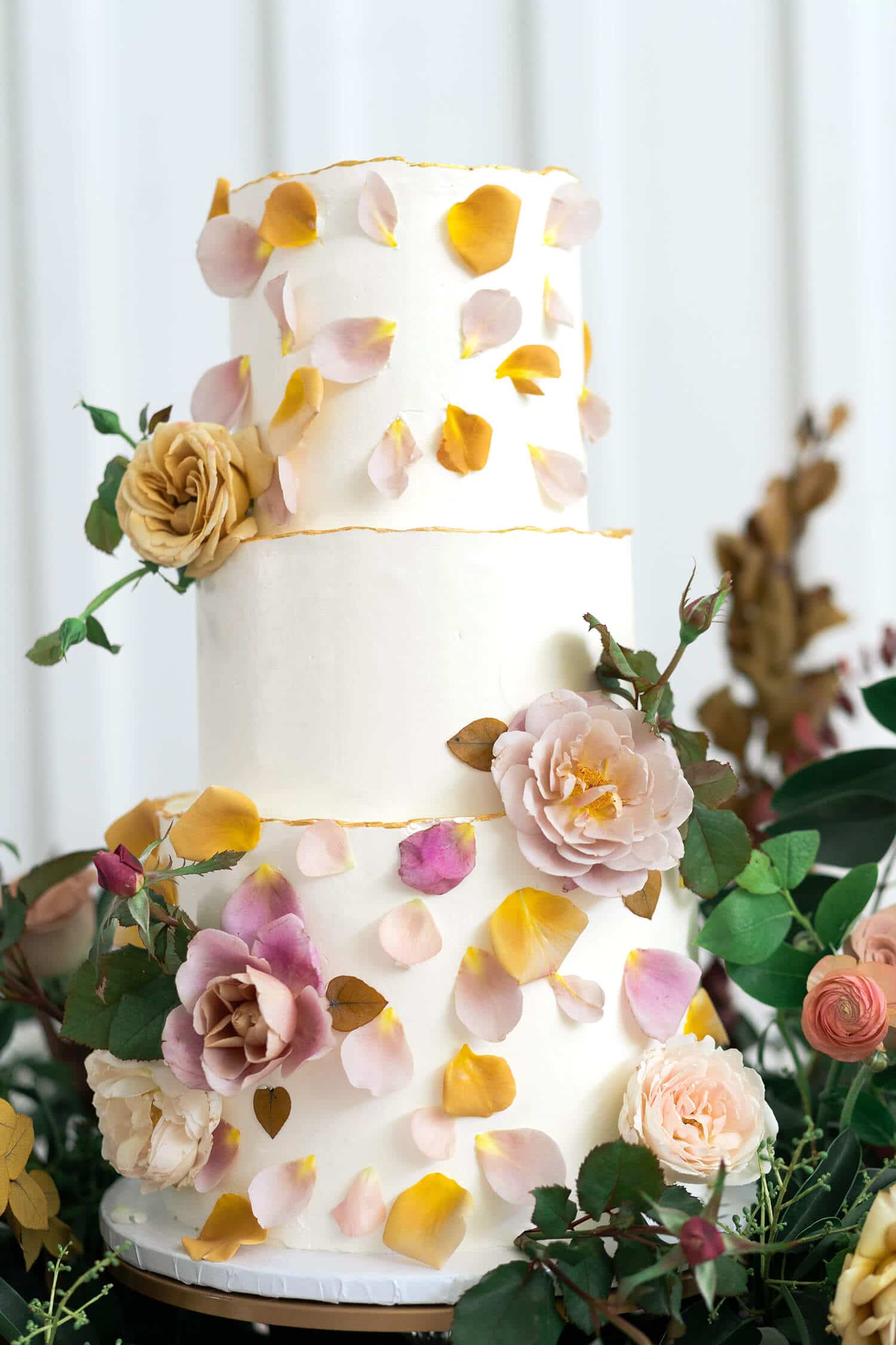 wedding cake adorned with rose petals at The Farmhouse in Montgomery Texas by Swish and Click Photography 15 essential questions
