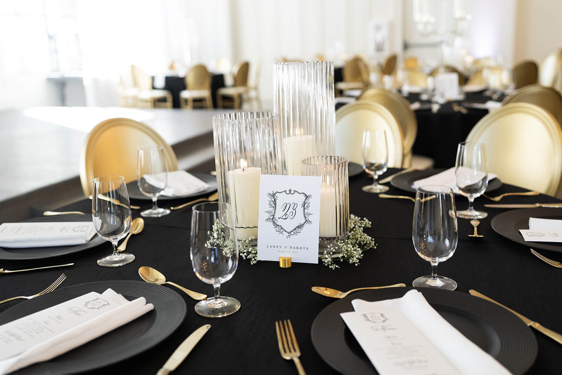 wedding reception table with wedding crest, flowers and cutlery at wedding venue 