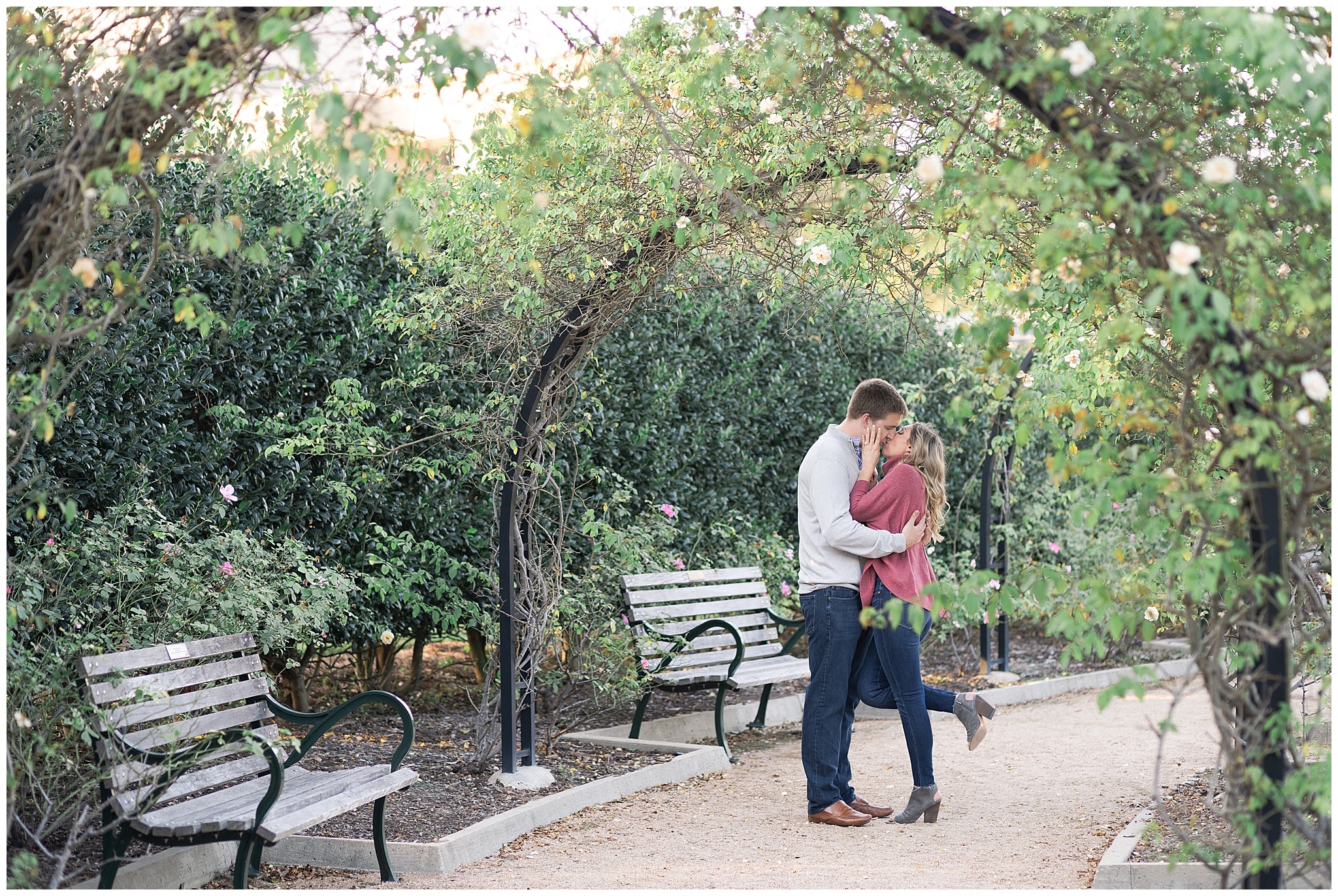 a couple kisses at their engagement photos at McGovern Centennial Gardens captured by Swish and Click Photography a Houston wedding photographer
