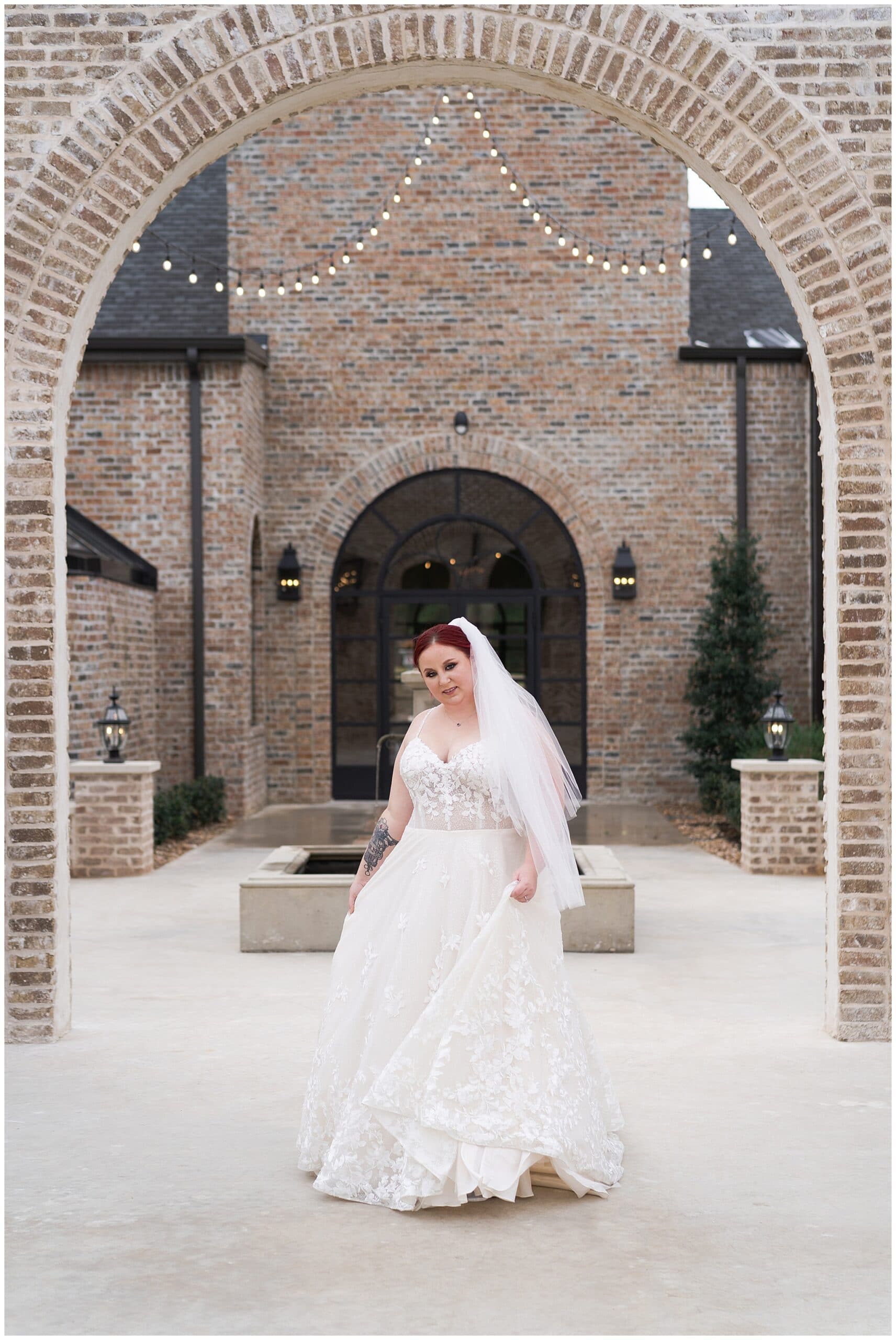bride plays with her gown during her Houston bridal session at Iron Manor captured by Swish and Click Photography