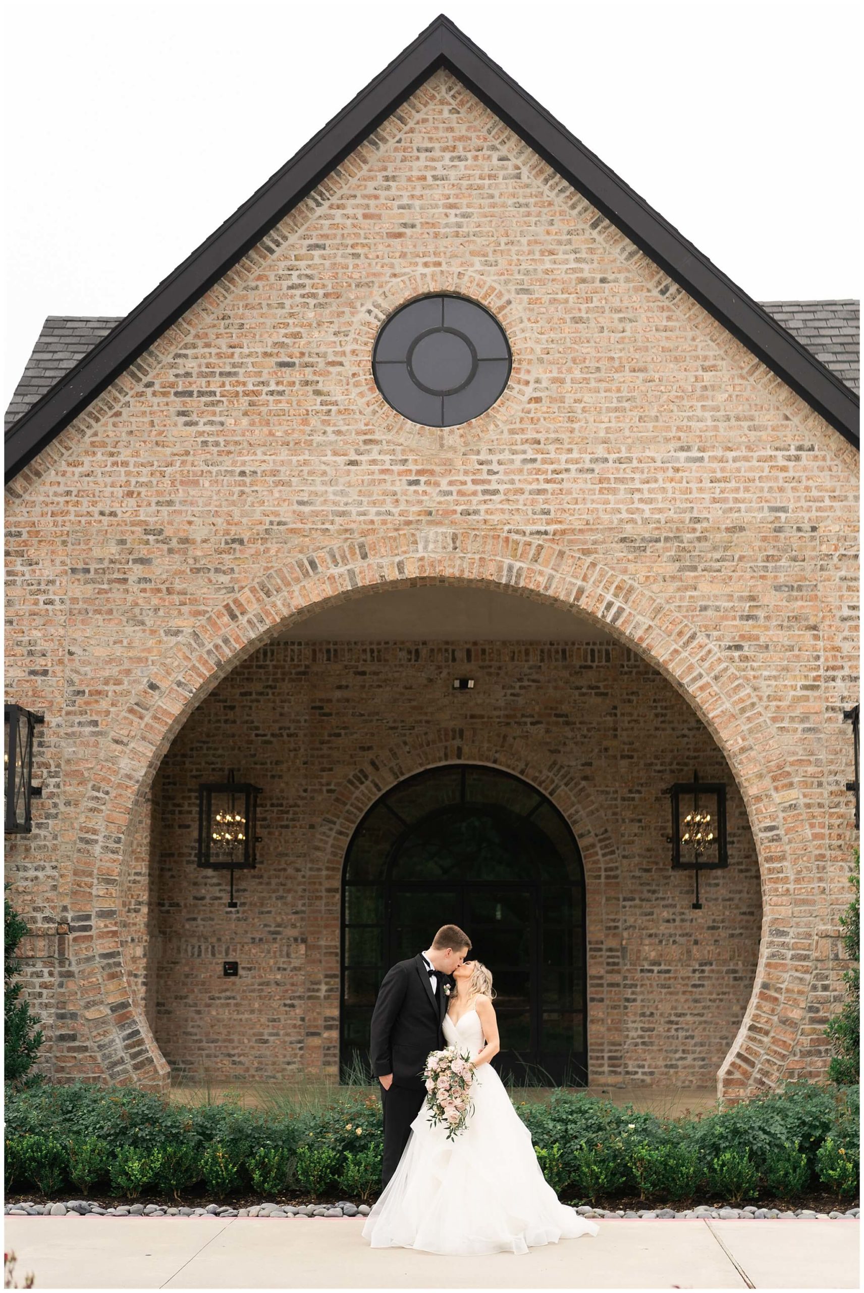 bride and groom kiss on their wedding day at Iron Manor in Houston Texas by Swish and Click Photography