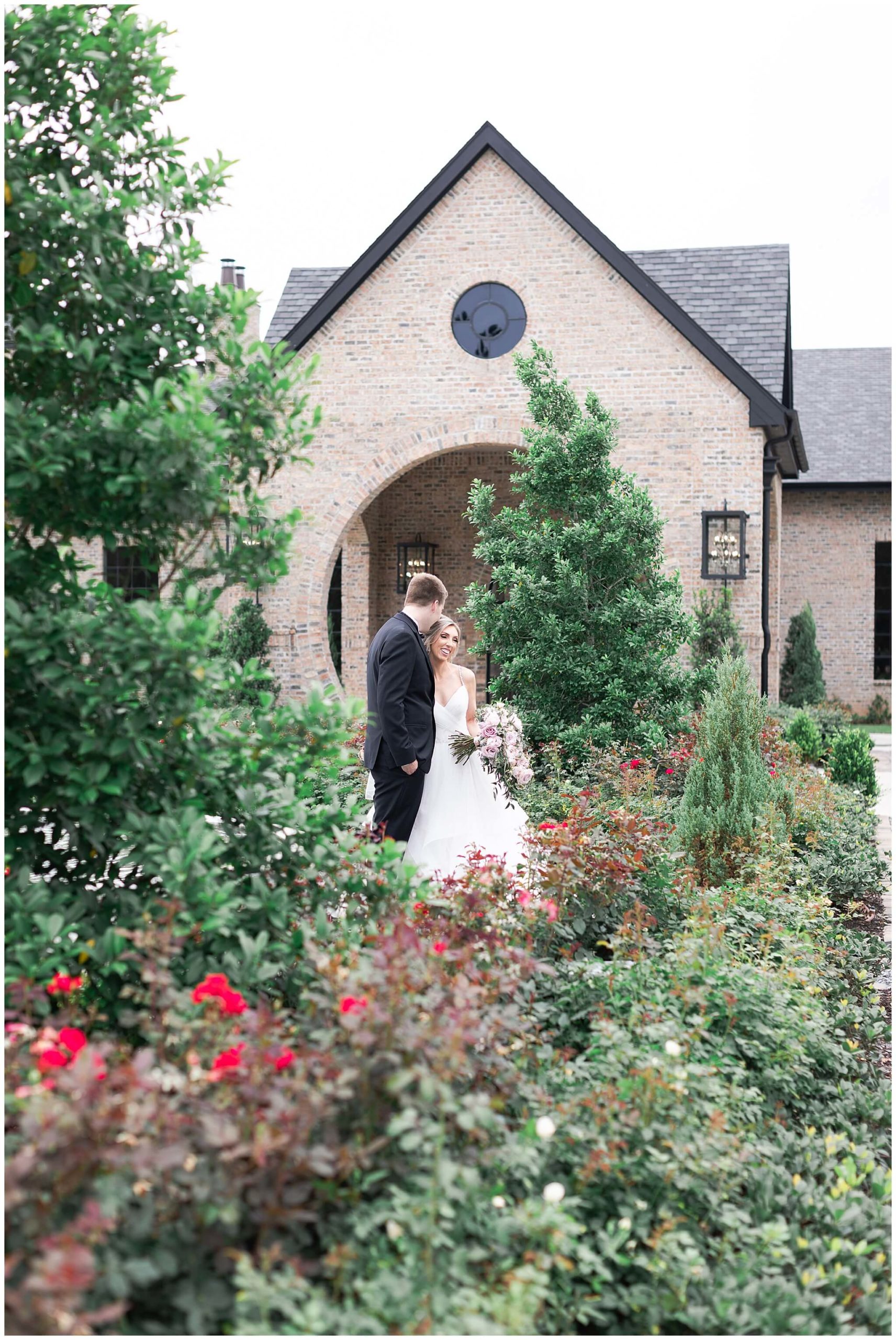 bride and groom smile during their wedding portraits  at Iron Manor in Houston Texas by Swish and Click Photography