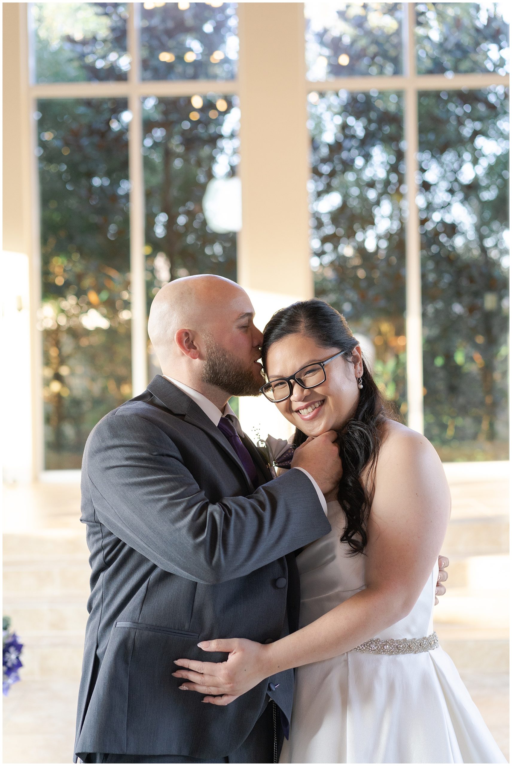 Houston wedding couple kiss during their first look at Ashton Gardens in Houston Texas by Swish and Click Photography