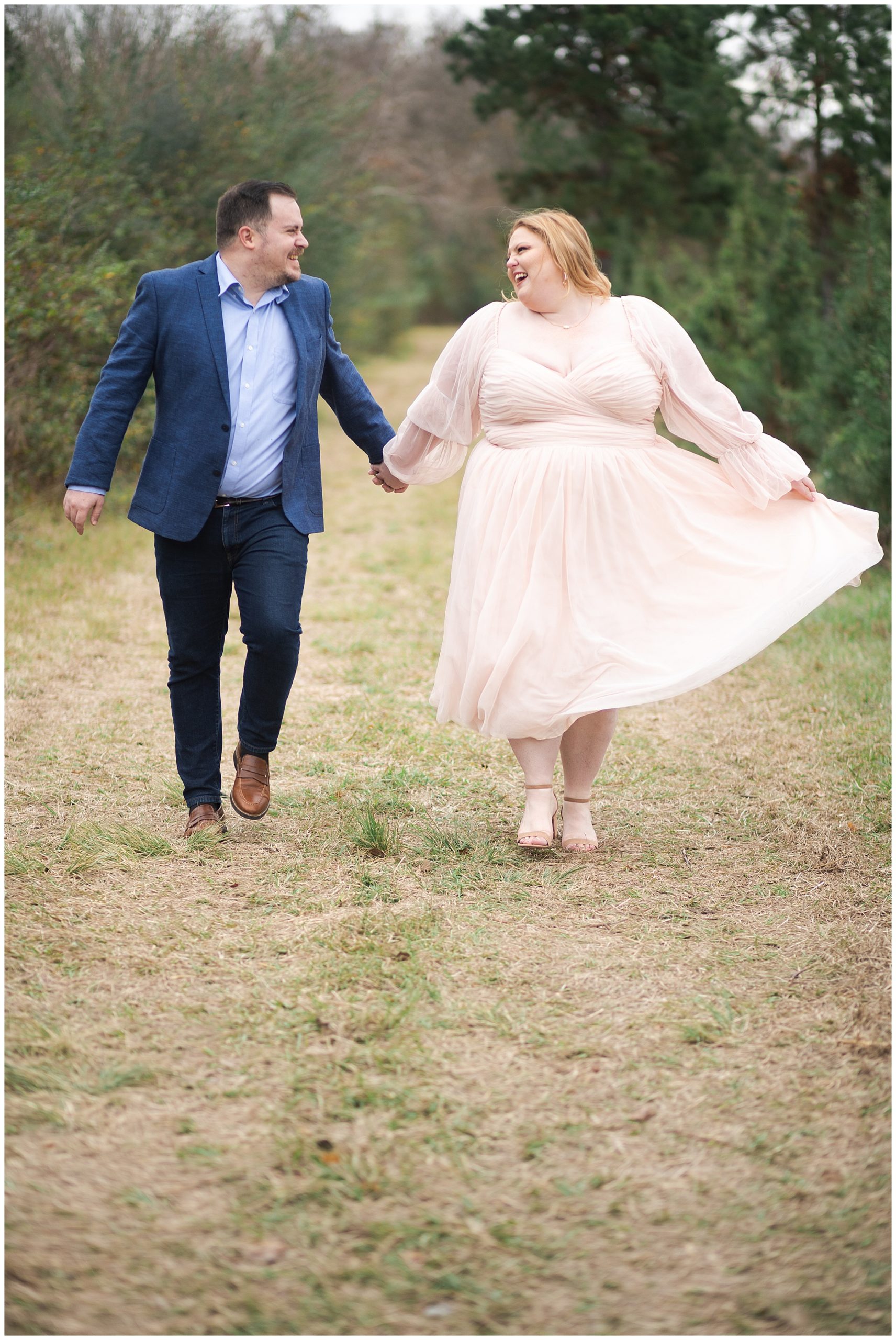 couple dance during their tree farm portrait session at Holiday Acres in Houston Texas by Swish and Click Photography