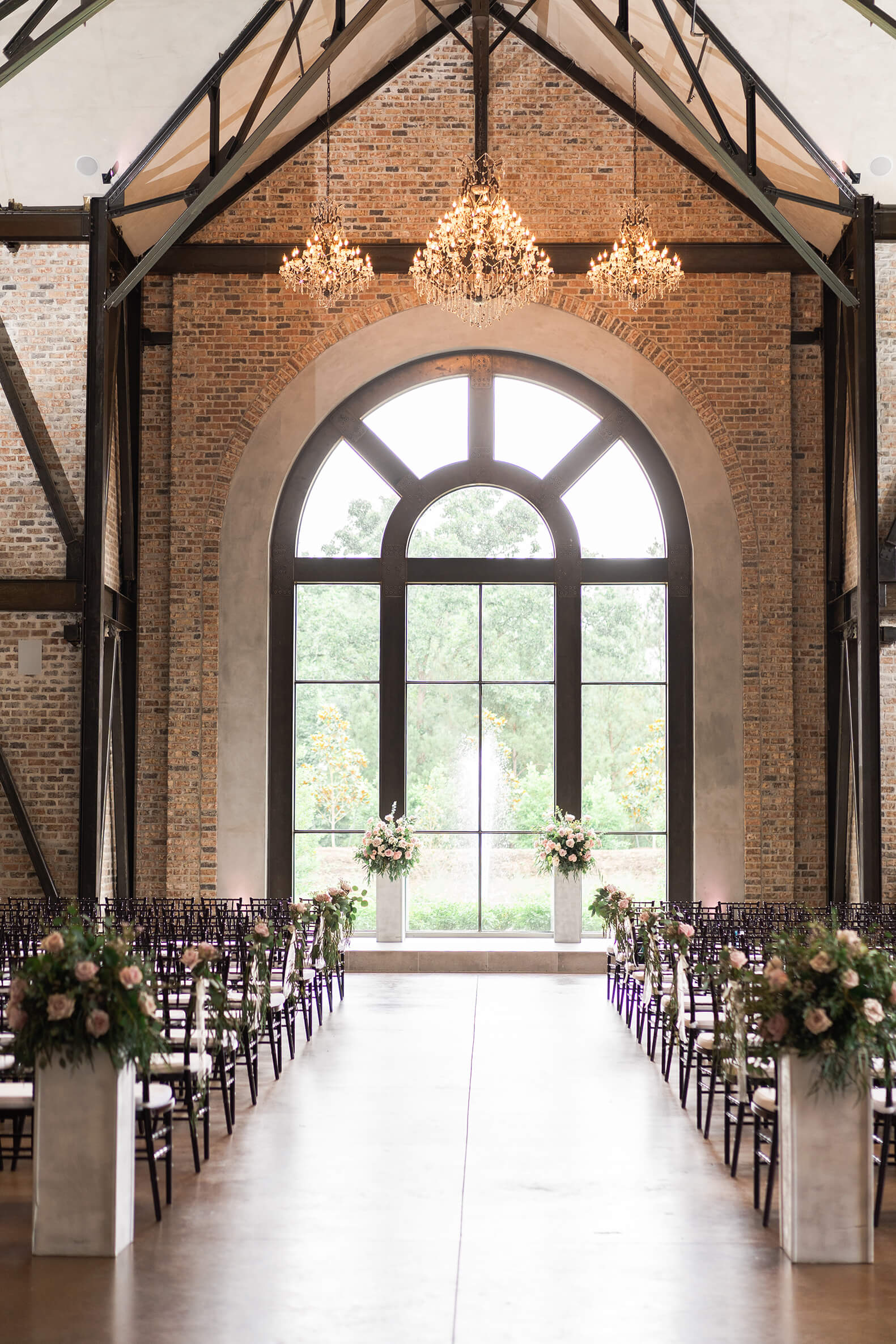 ceremony space with large windows and flowers at Iron Manor in Houston Texas by Swish and Click Photography