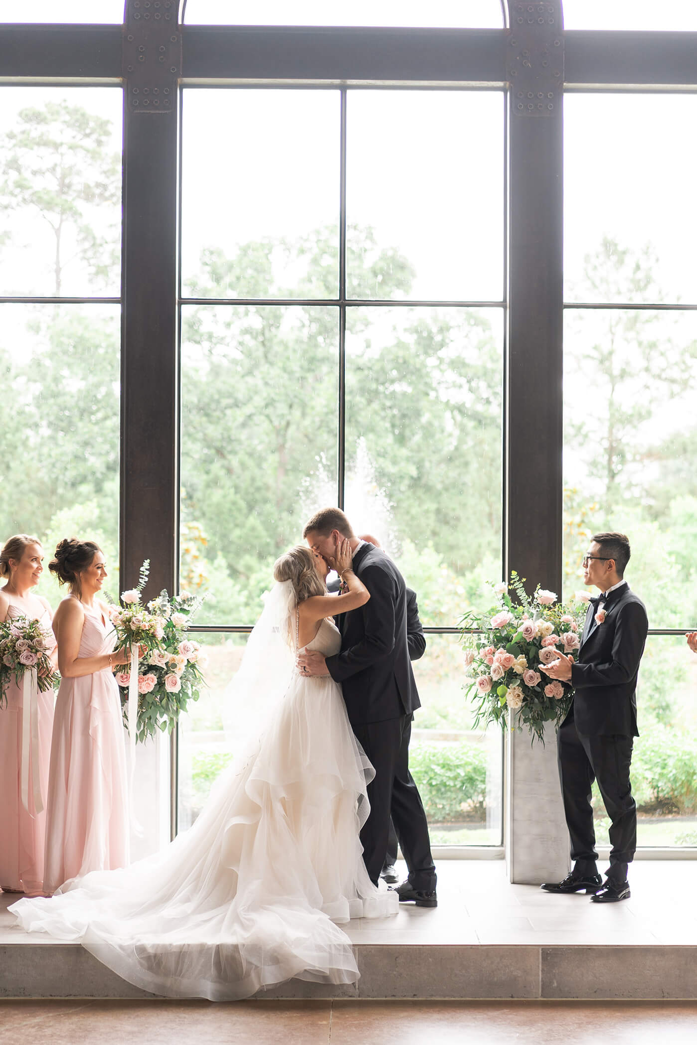 wedding couple's first kiss on their wedding day at Iron Manor in Houston Texas by Swish and Click Photography