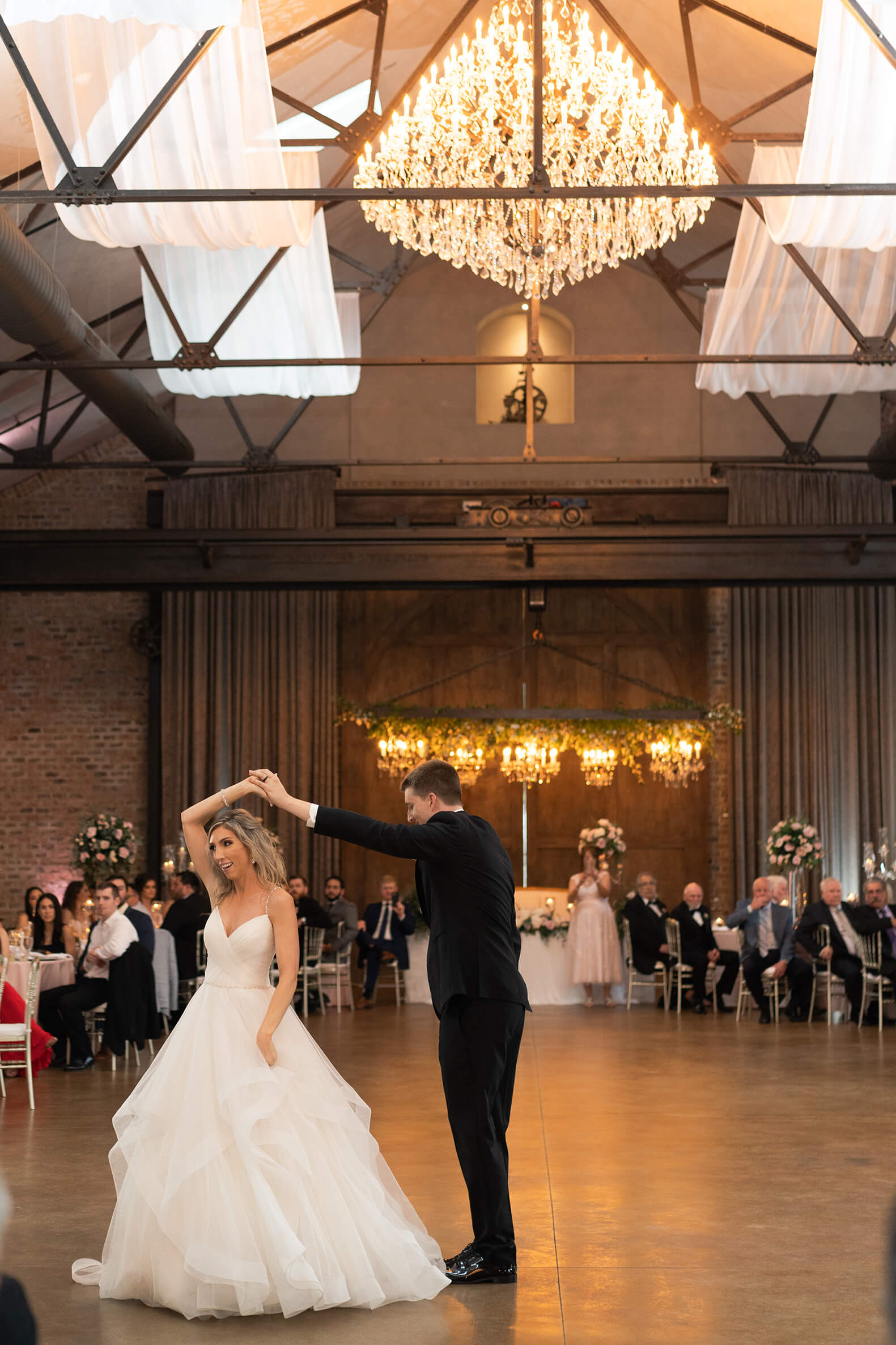bride and groom dance during their first dance on their wedding dat reception space in Crane Hall at Iron Manor in Houston Texas by Swish and Click Photography