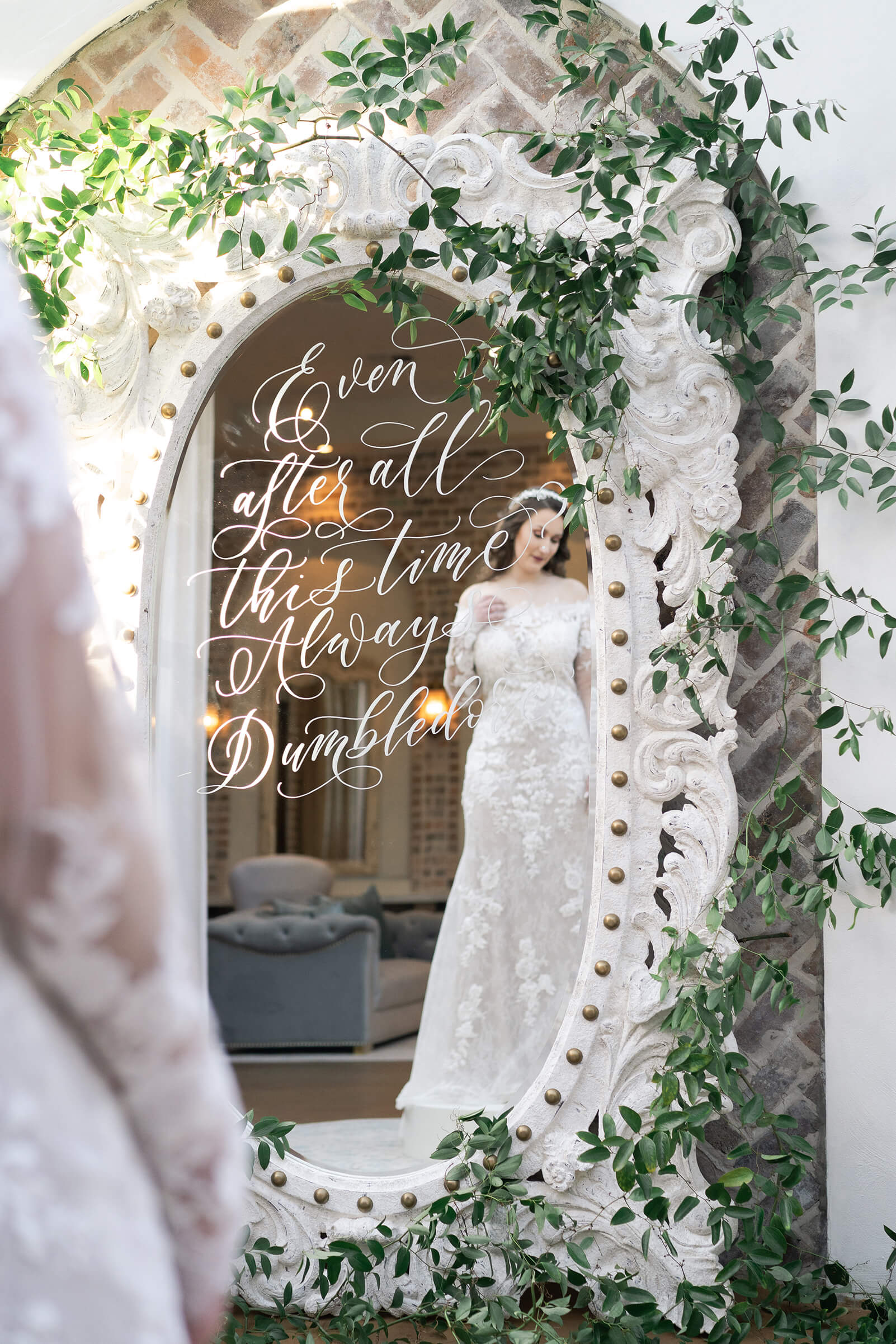 bride looks at herself in the mirror as she gets ready on her wedding day reception space at Iron Manor in Houston Texas by Swish and Click Photography