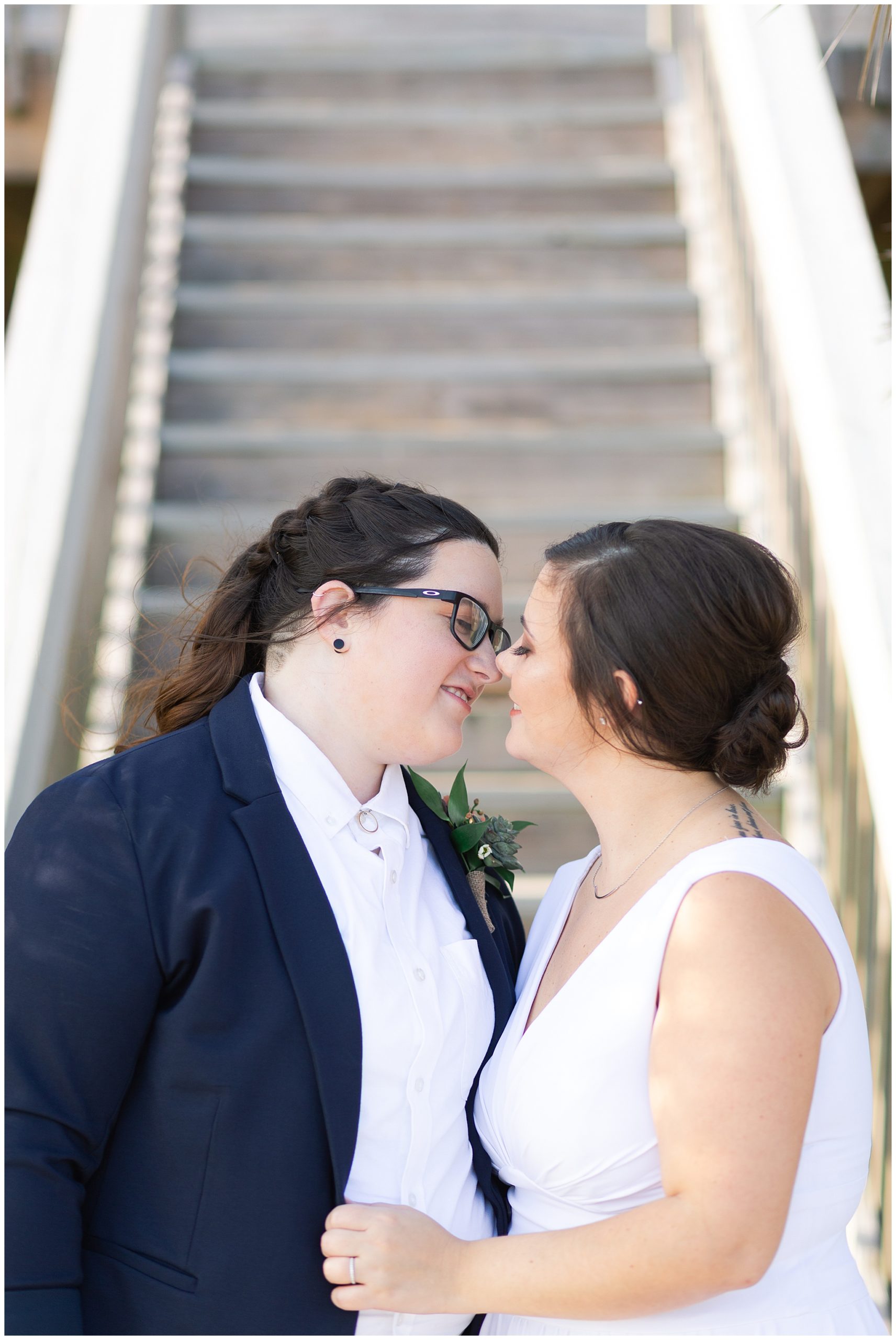 two brides share a wedding day kiss at a beach house in Galveston Texas by Swish and Click Photography