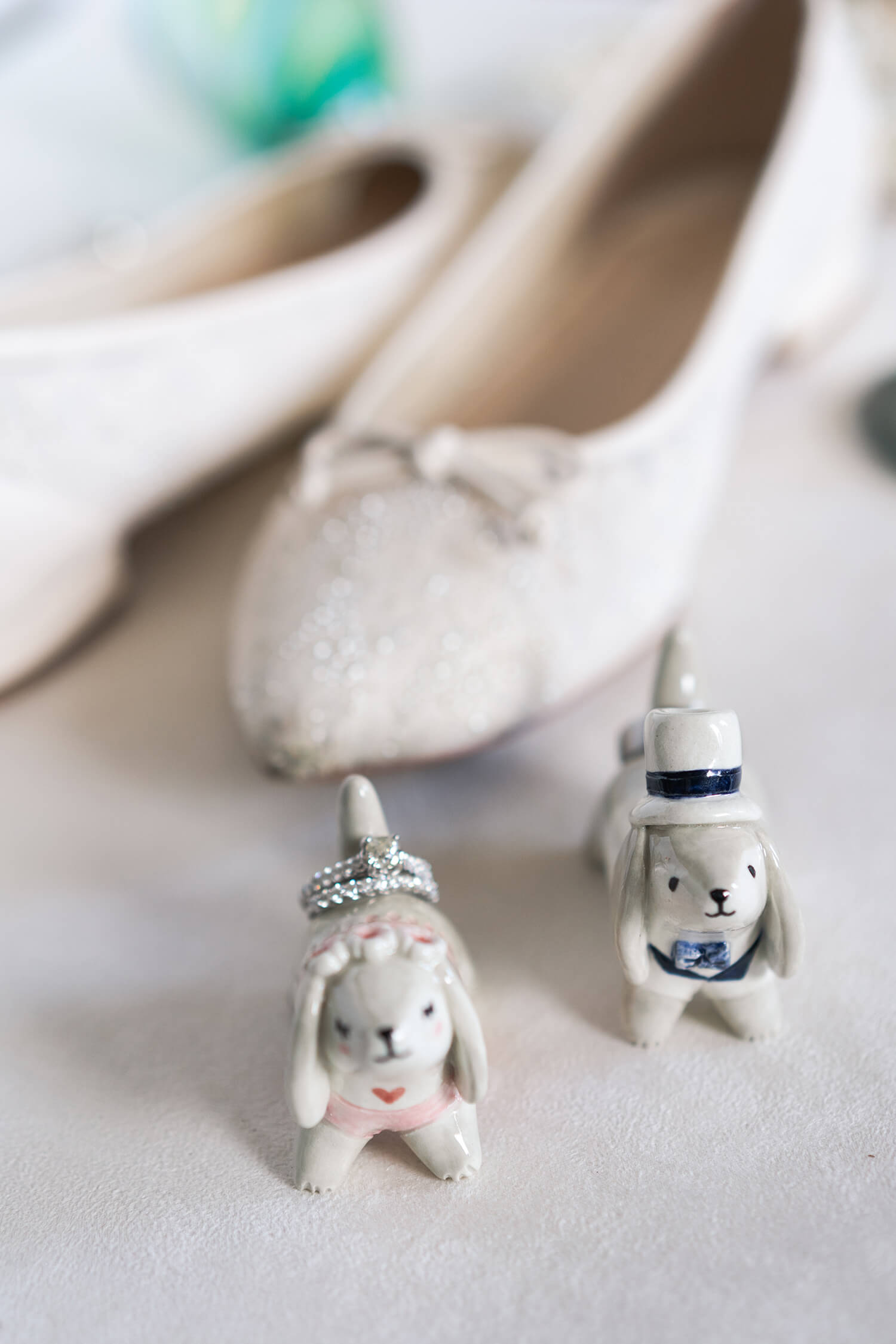 porcelain dog ring holders have wedding bands on them at Hotel Zaza in Houston Texas by Swish and Click Photography