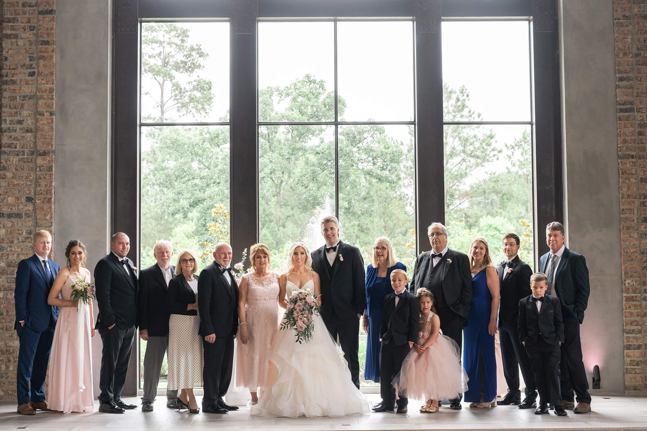 a large family poses during formal family portraits at Iron Manor in Houston Texas by Swish and Click Photography