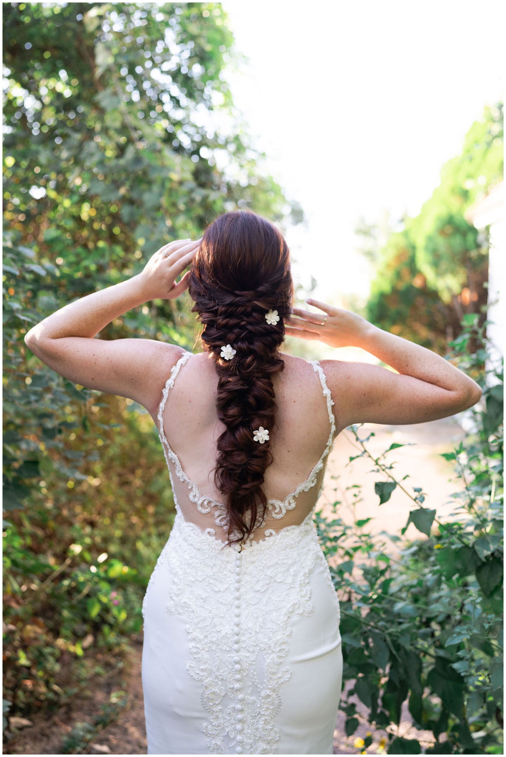 bride caresses her hair during her bridal session at Barr Mansion in Austin Texas by Swish and Click Photography