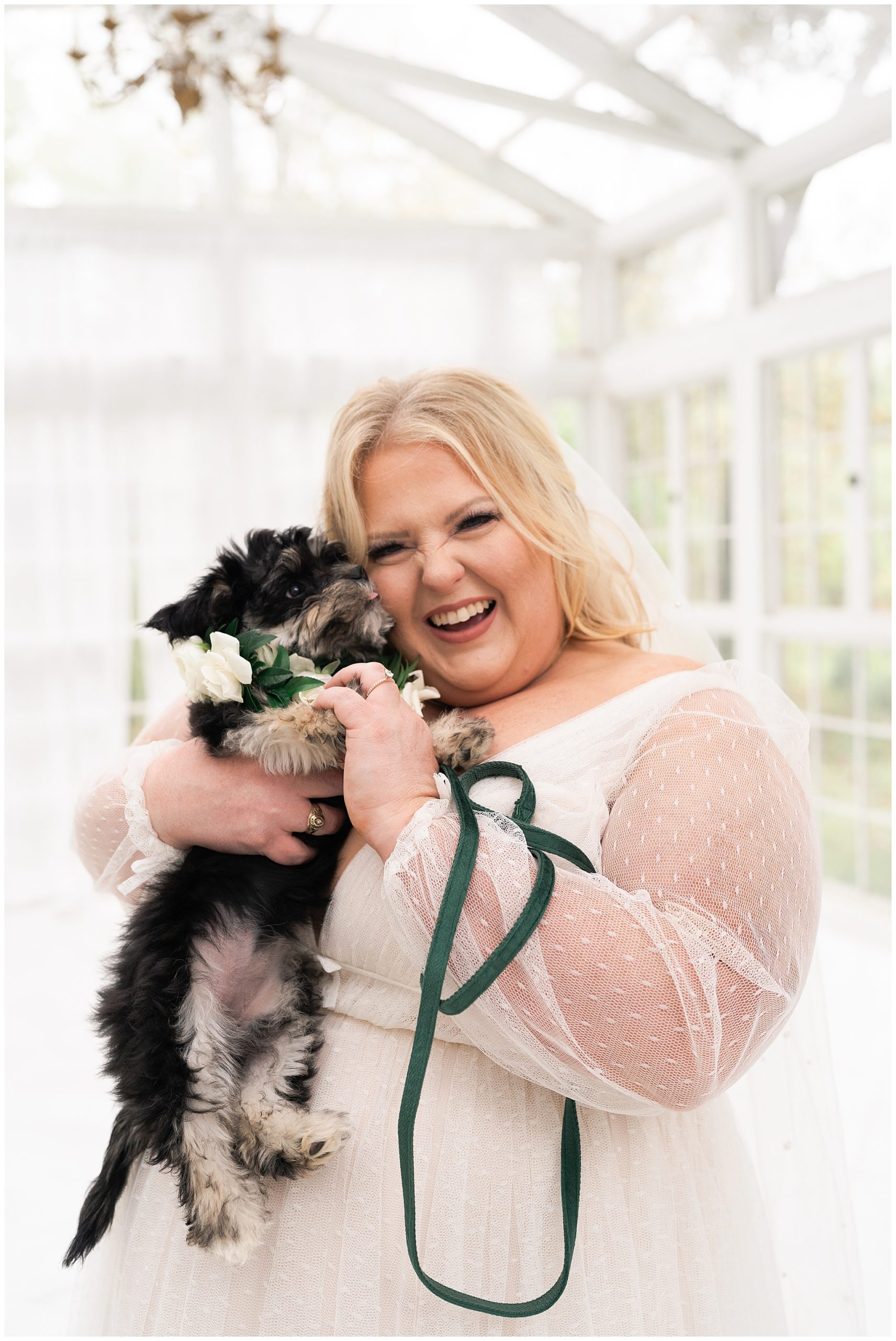 bride smiles with her dog Waffles in her wedding gown at the Oak Atelier in Houston by Swish and Click Photography