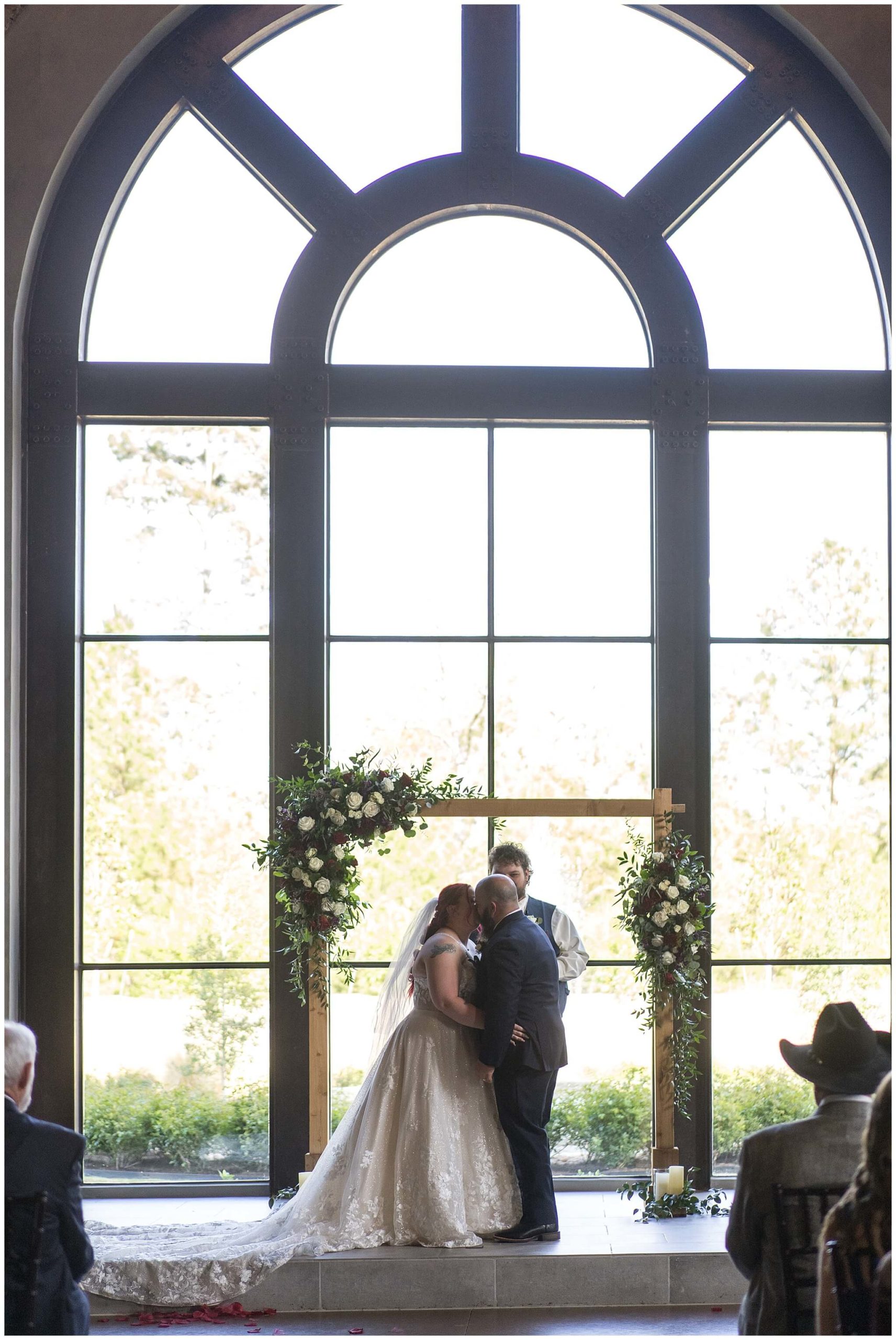 first kiss as a married couple at Iron Manor in Houston Texas by Swish and Click Photography