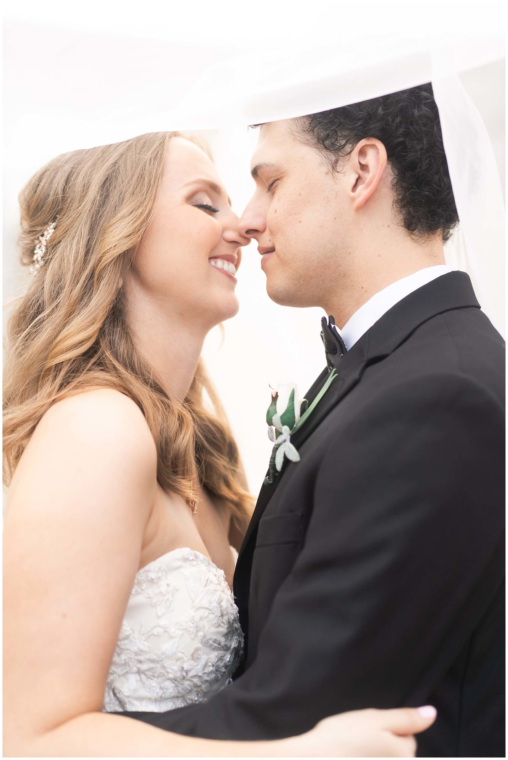 bride and groom almost kiss during their portraits at Mecom Rockwell Colonnade by Houston wedding photographer Swish and Click Photography