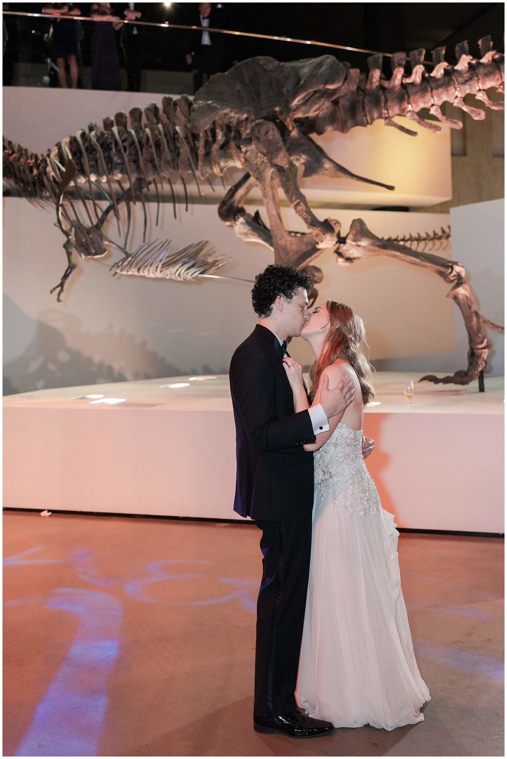 bride and groom have a private last dance at the Museum of Natural Science by Houston wedding photographer Swish and Click Photography
