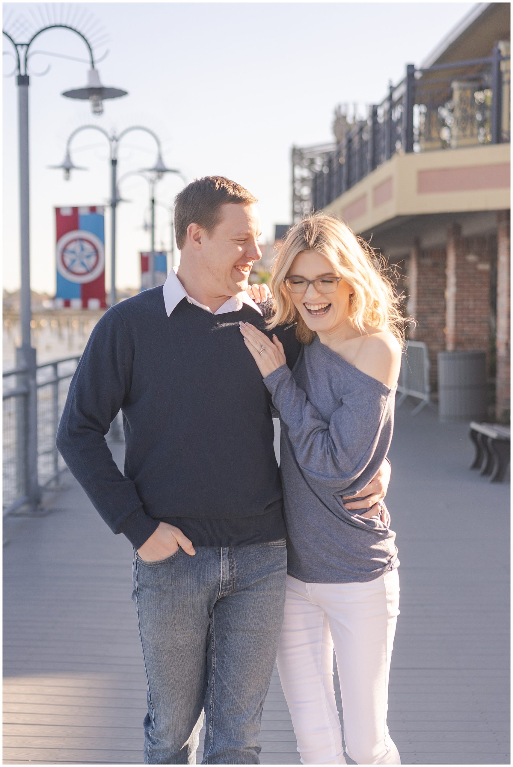 engaged couple walk on the Kemah Boardwalk during their engagement session by Houston's best wedding photographers Swish and Click Photography