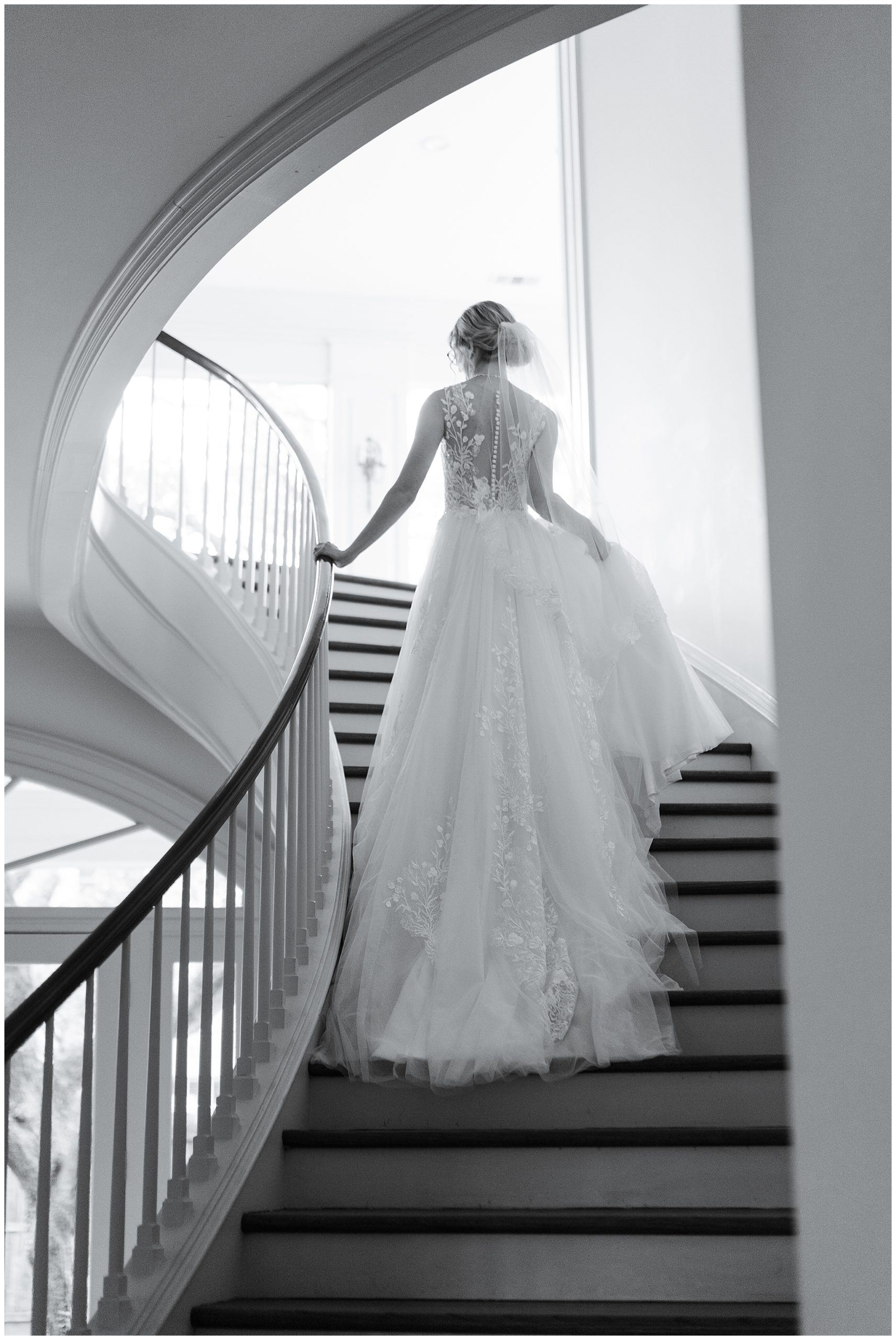 bride goes up the stairs in her wedding gown at the Creative Chateau