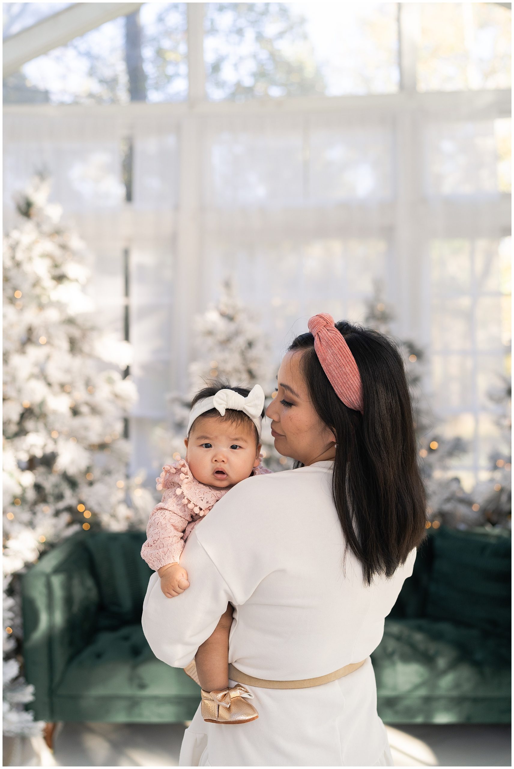 mom poses with her daughter for Christmas photos at the Oak Atelier in Houston Texas by photographer Swish and Click Photography