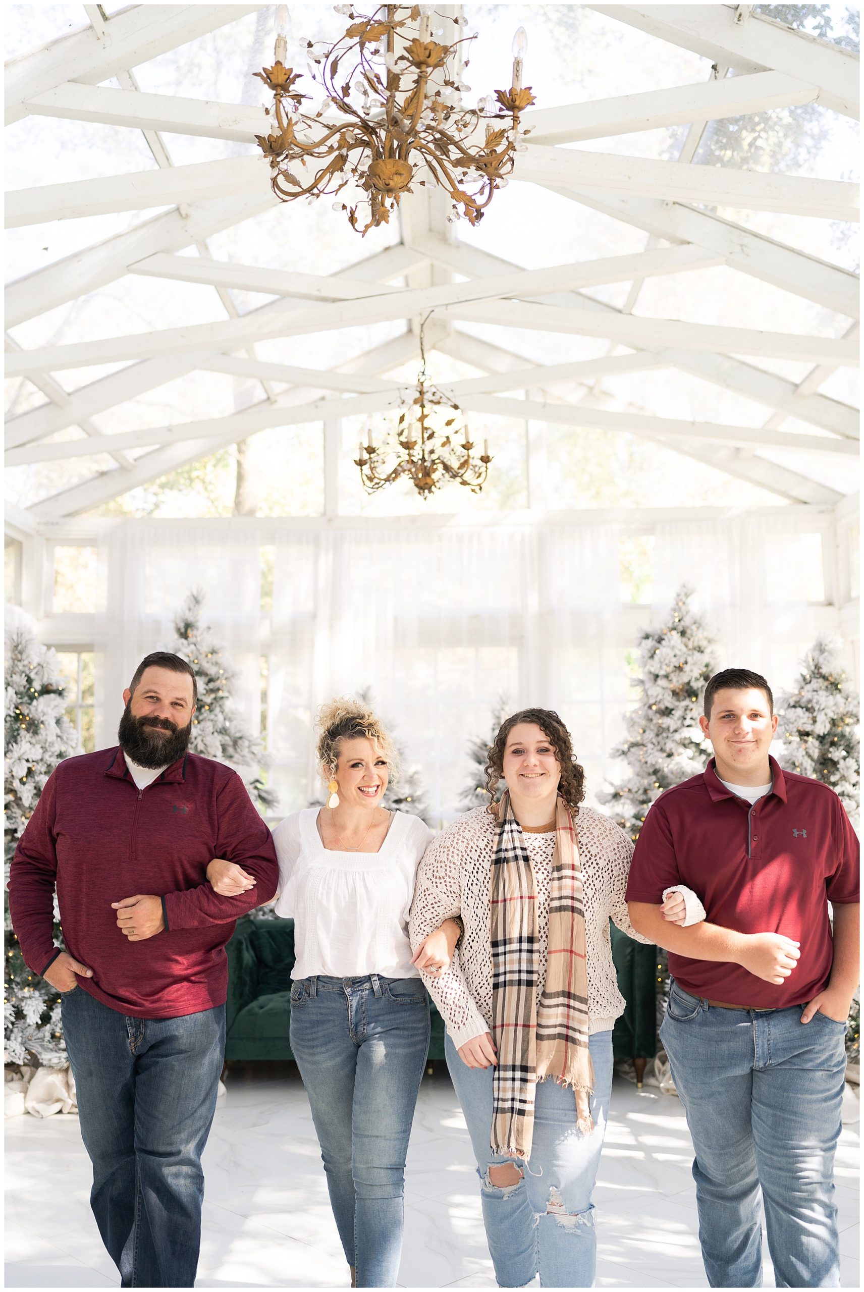 family walks during their Christmas photos at the Oak Atelier in Houston Texas by photographer Swish and Click Photography