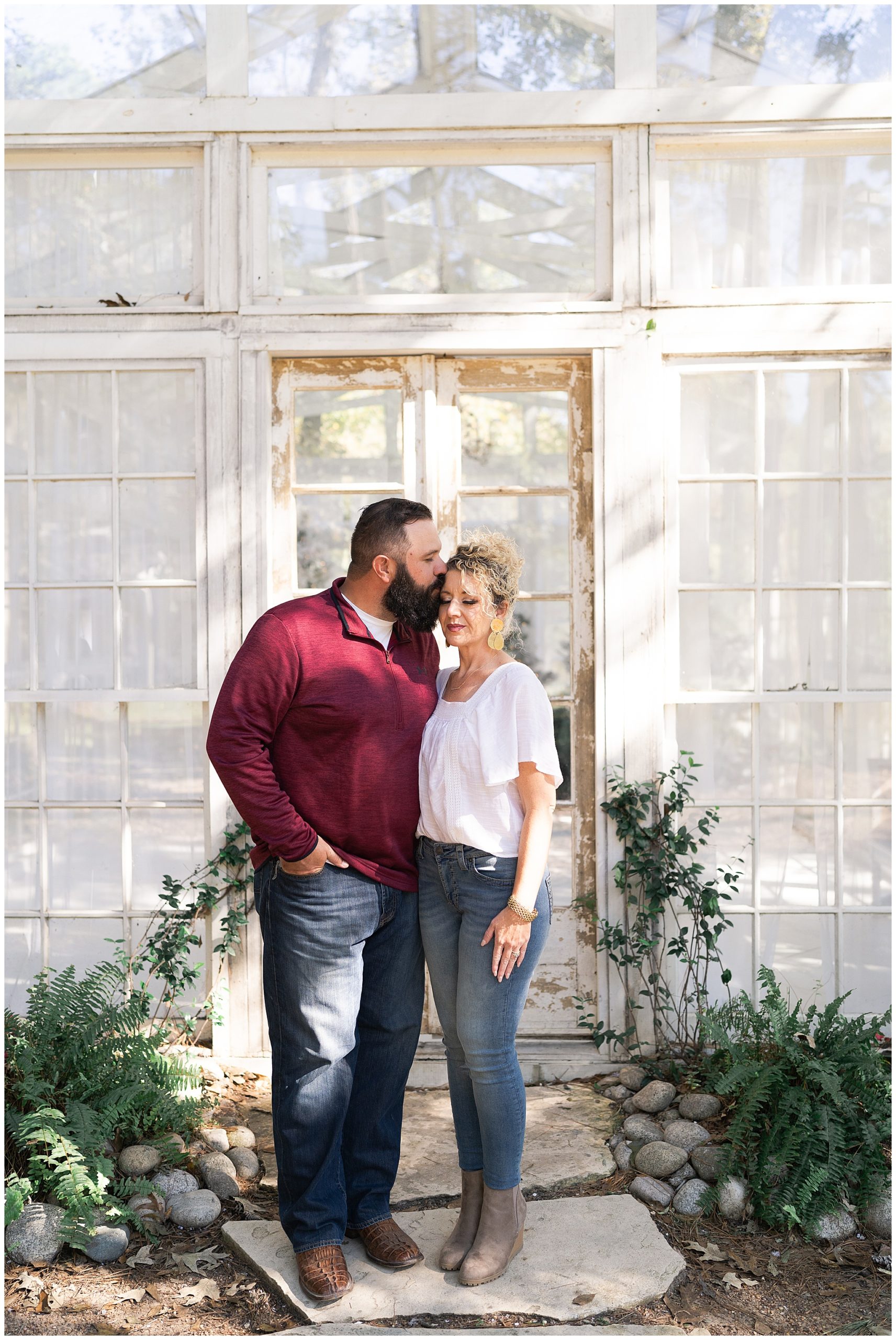 mom and dad kiss during Christmas photos at the Oak Atelier in Houston Texas by photographer Swish and Click Photography