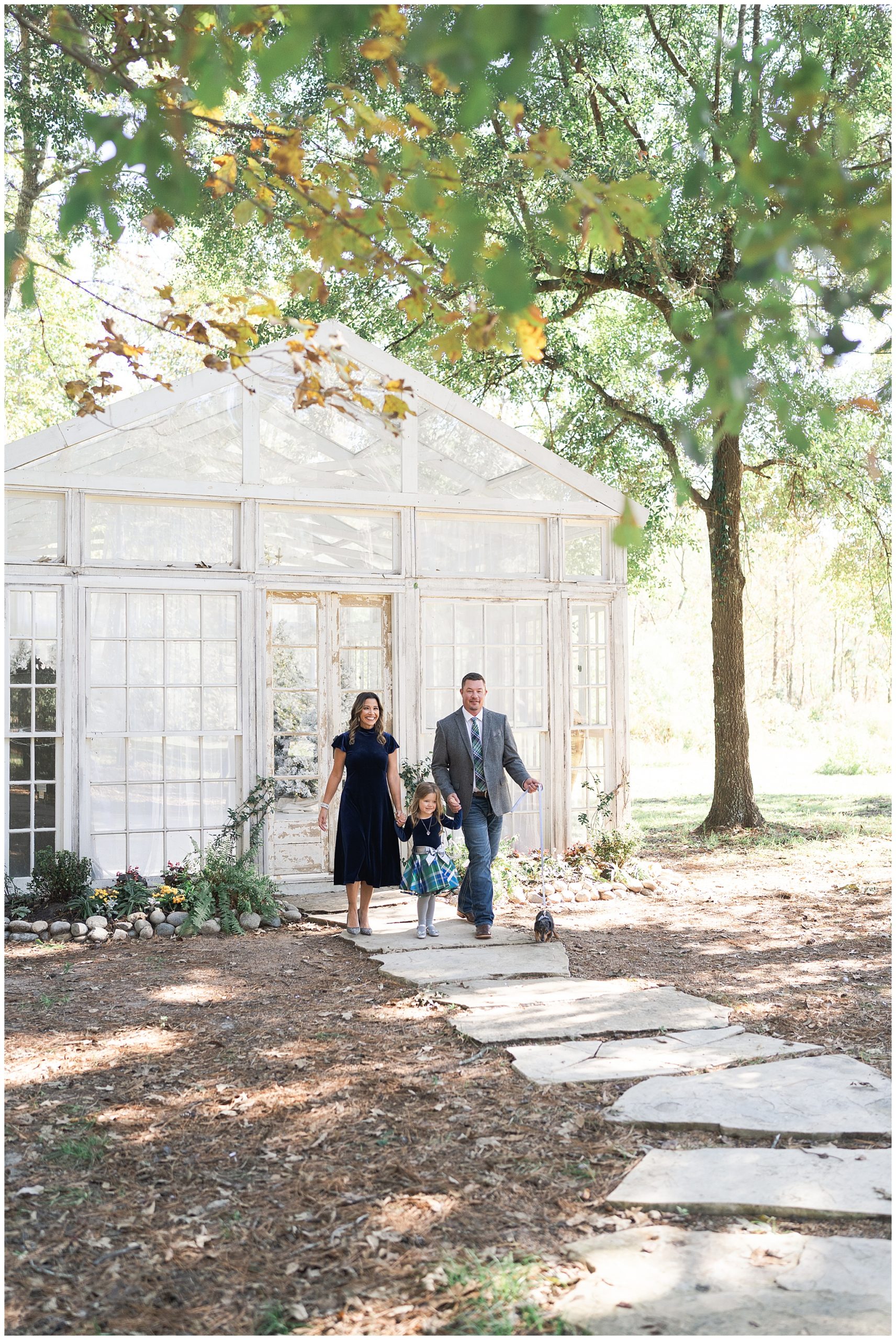 family walks together during photos at a greenhouse in Houston Texas by photographer Swish and Click Photography