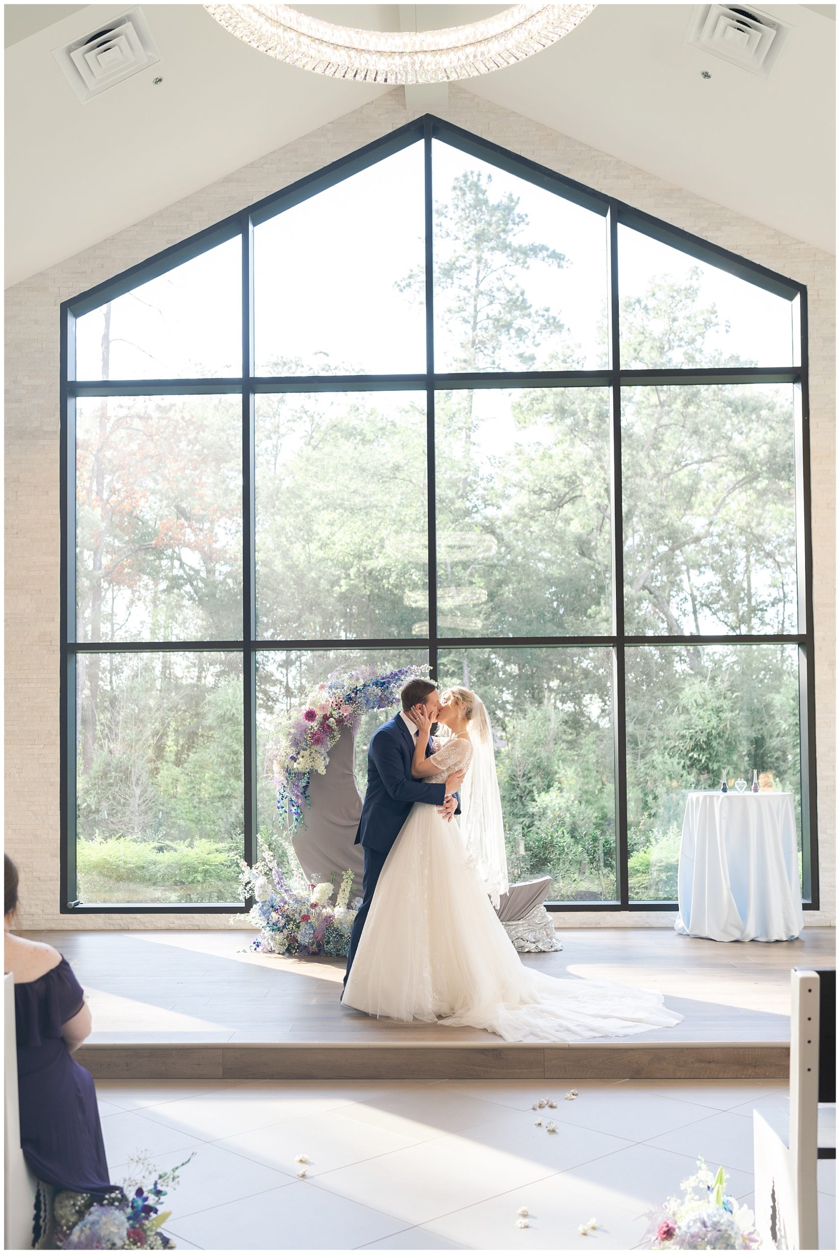 kiss the bride at the luminaire by Houston's best wedding photographers Swish and Click Photography