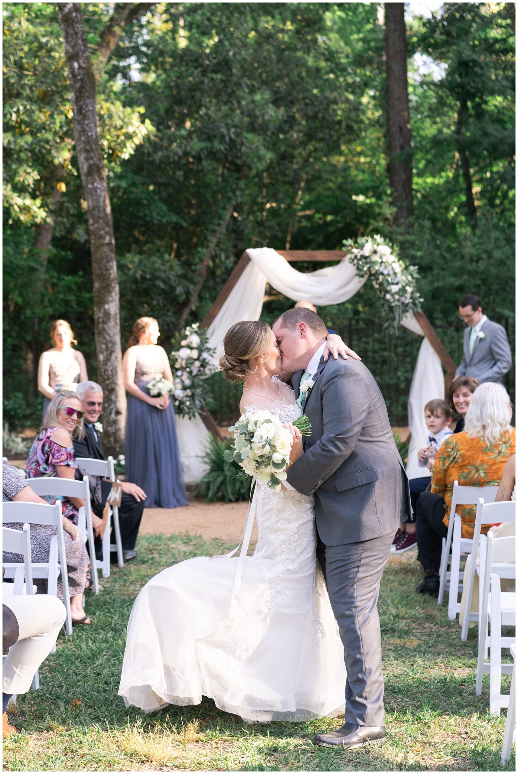bride and groom kiss by Houston wedding photographer Swish and Click Photography
