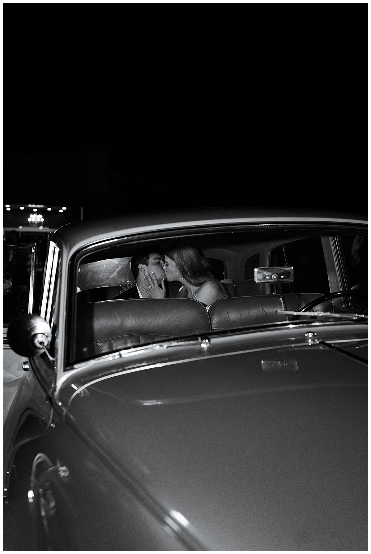 Husband and wife kiss in old classic car by Swish & Click Photography