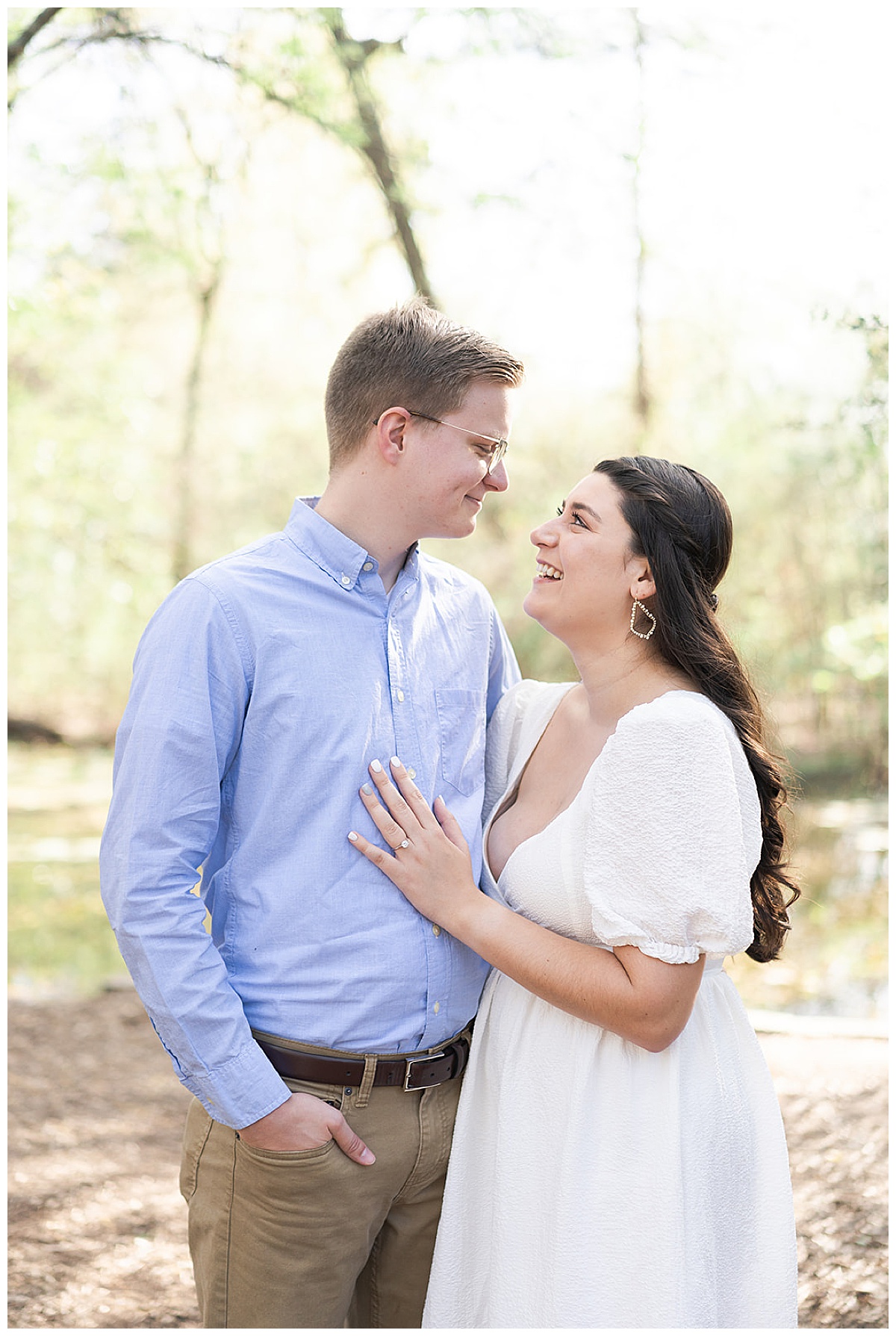 Man and woman smile together for Houston Arboretum Engagement Session