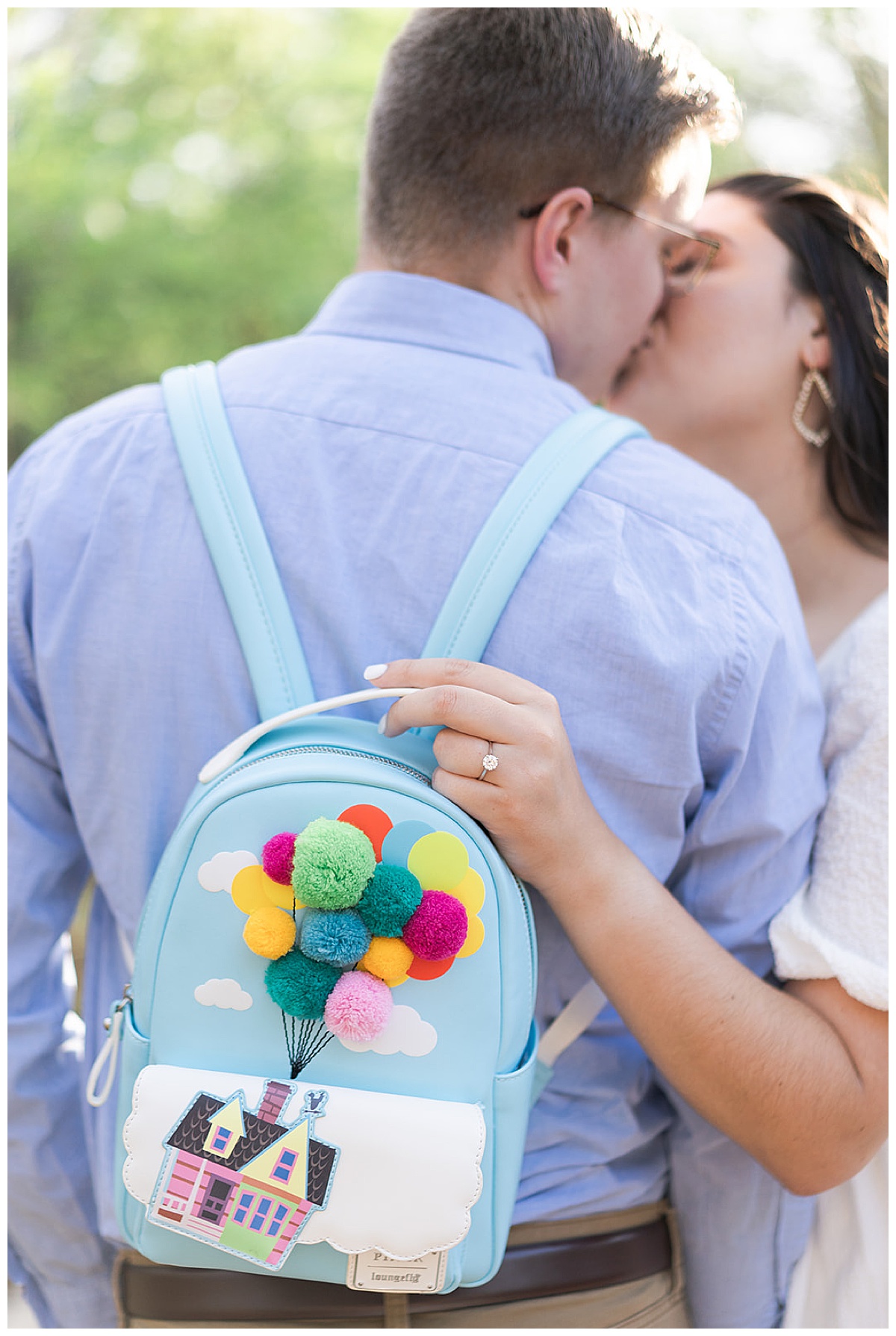Couple share a kiss with Disney backpack for Swish & Click Photography