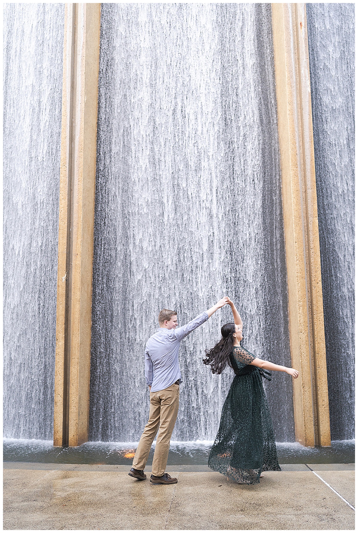 Man twirls woman at waterfall by Houston's Best Wedding Photographers