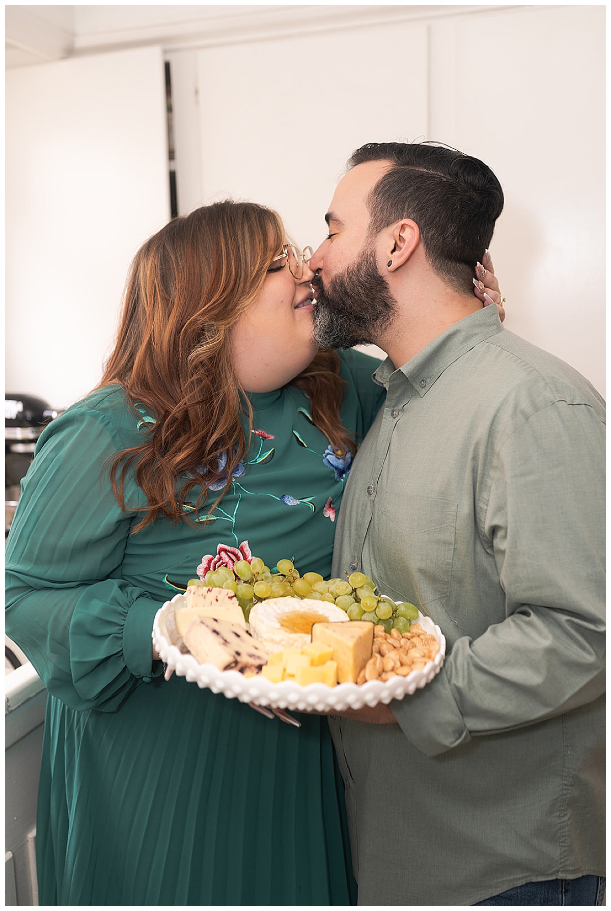 Two people kiss in kitchen for Swish & Click Photography