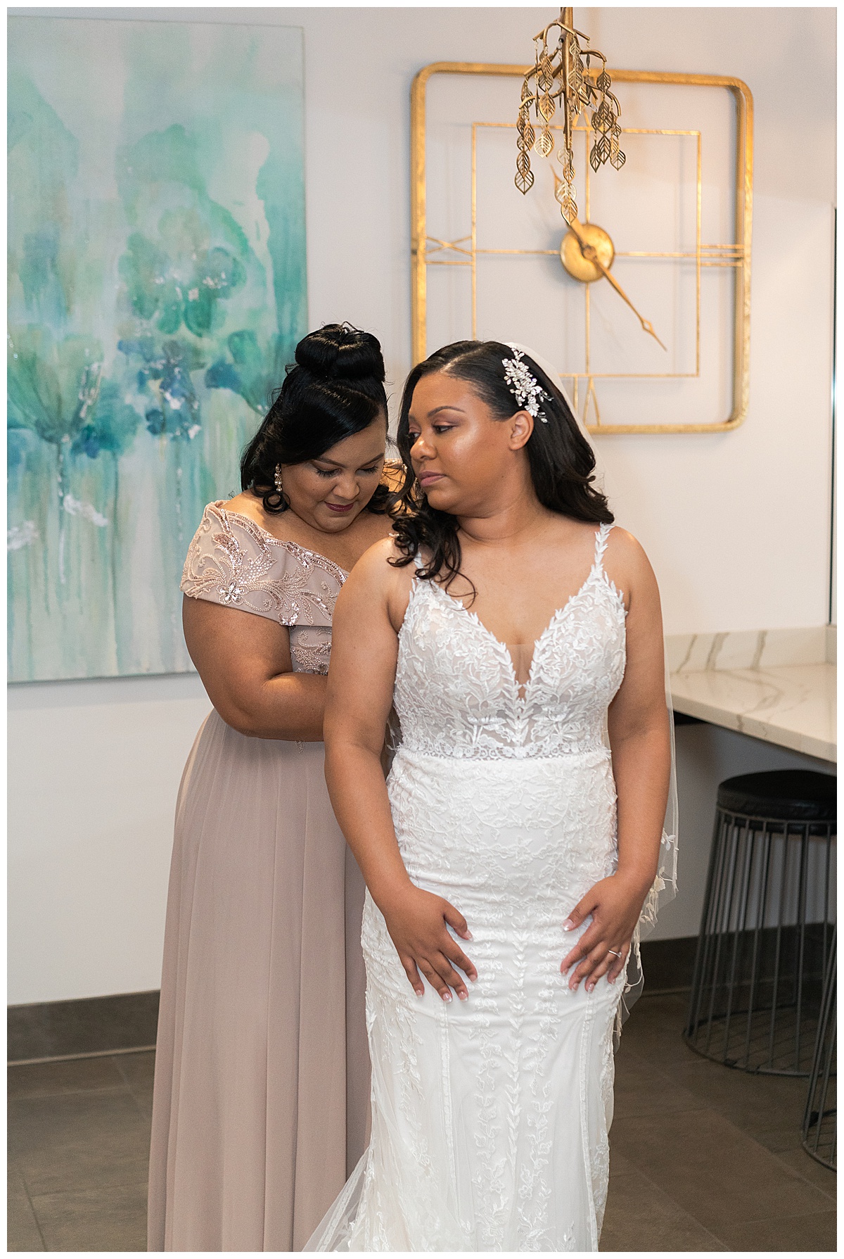 Woman helps bride with dress at The Bowery House & Gardens