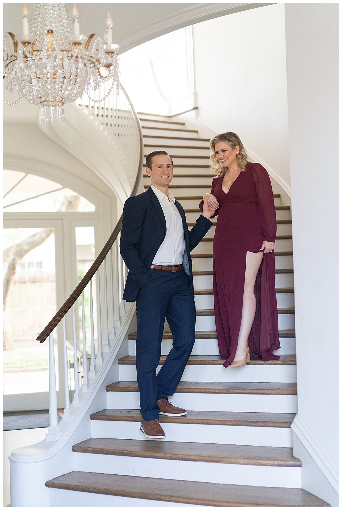 Man leads woman down the stairs for their Modern Romantic Engagement Session