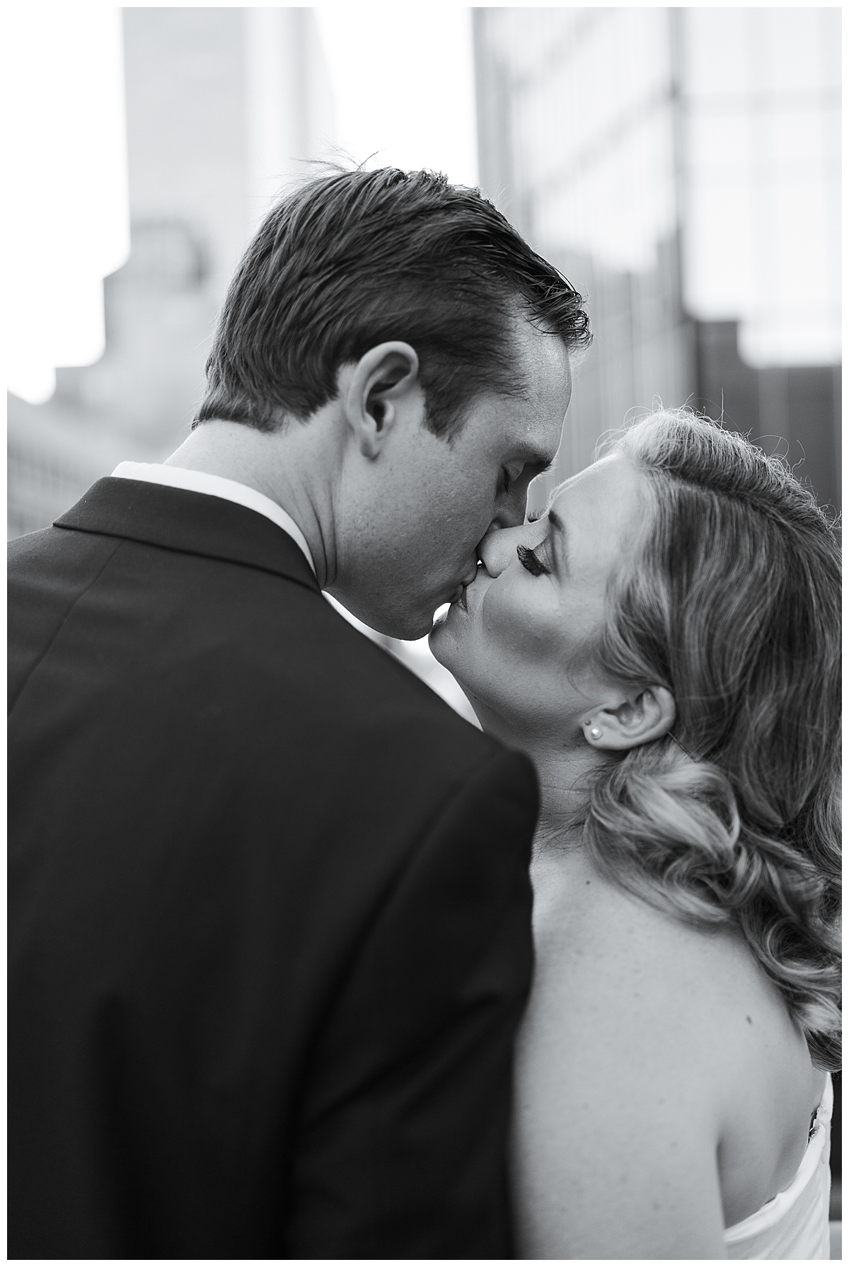 Man and woman exchange a kiss for their Modern Romantic Engagement Session