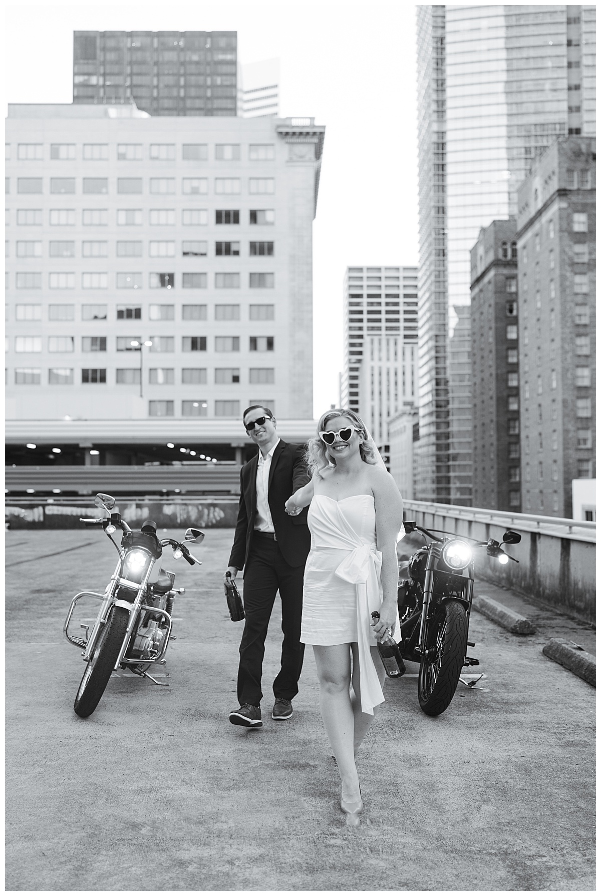 Future bride leads groom walking in on rooftop with motorcycle for Swish & Click Photography