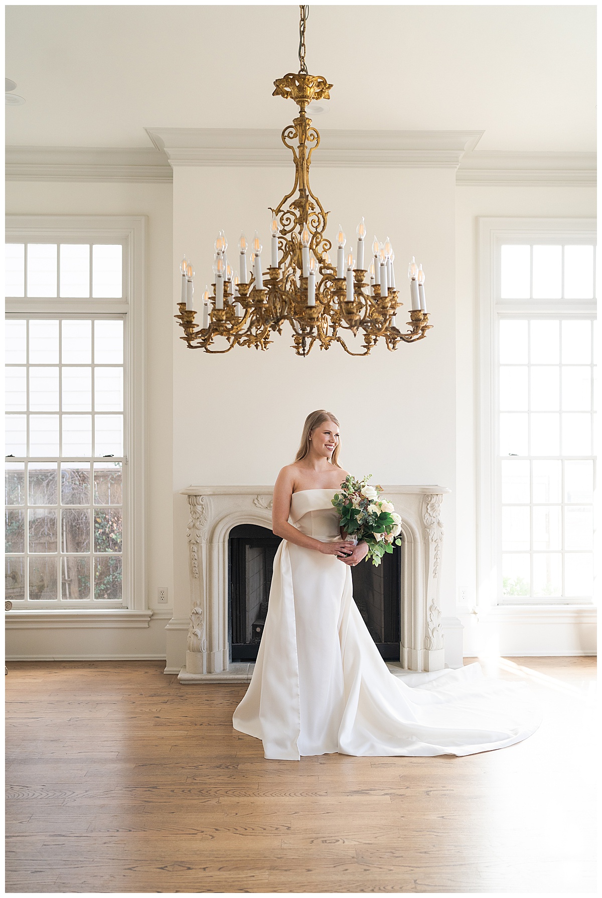 Woman stands under chandelier for bridal portraits for Houston’s Best Wedding Photographers 
